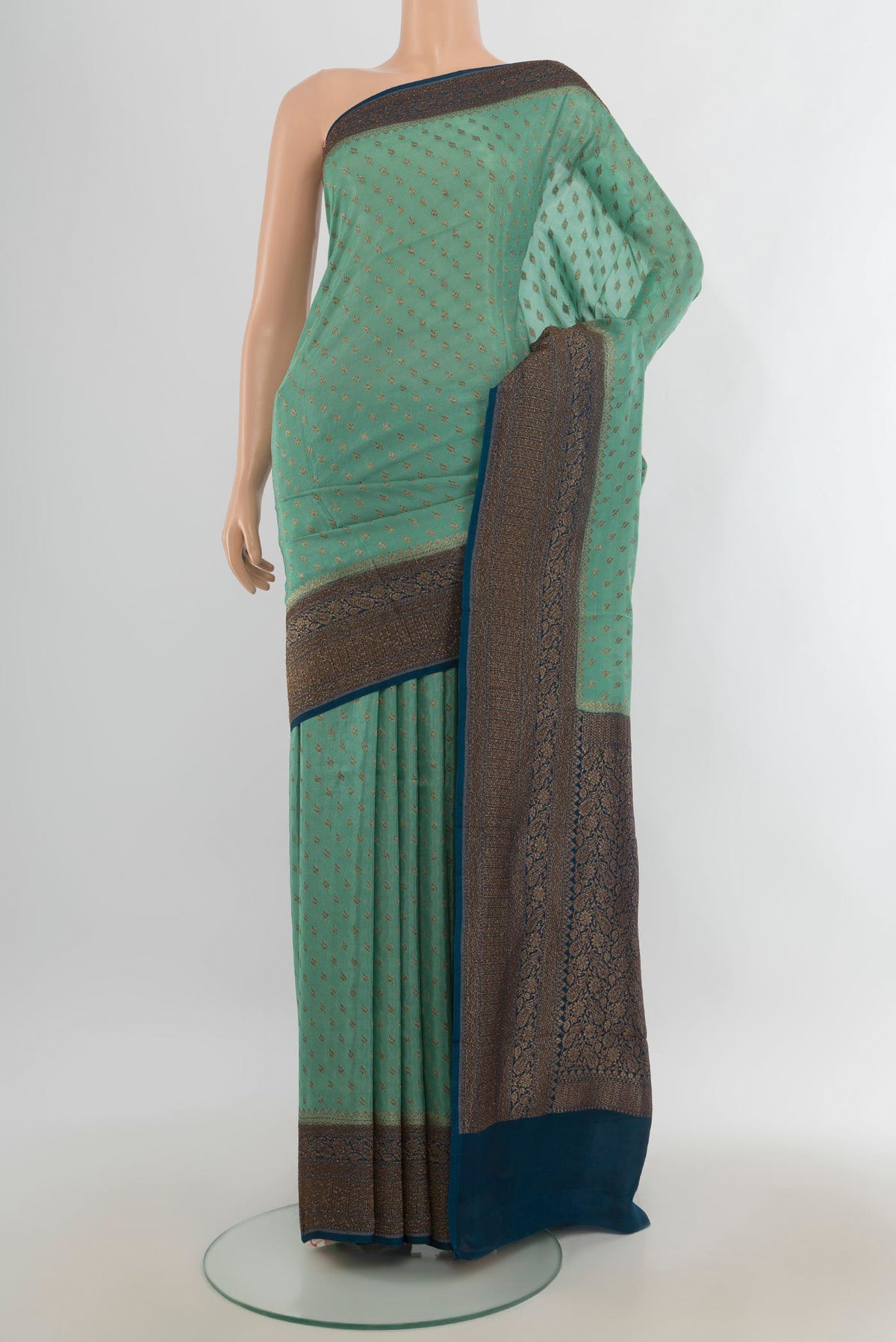 Burgundy Art Saree with Zari Butta on the body and Silk Border.  displayed on a mannequin