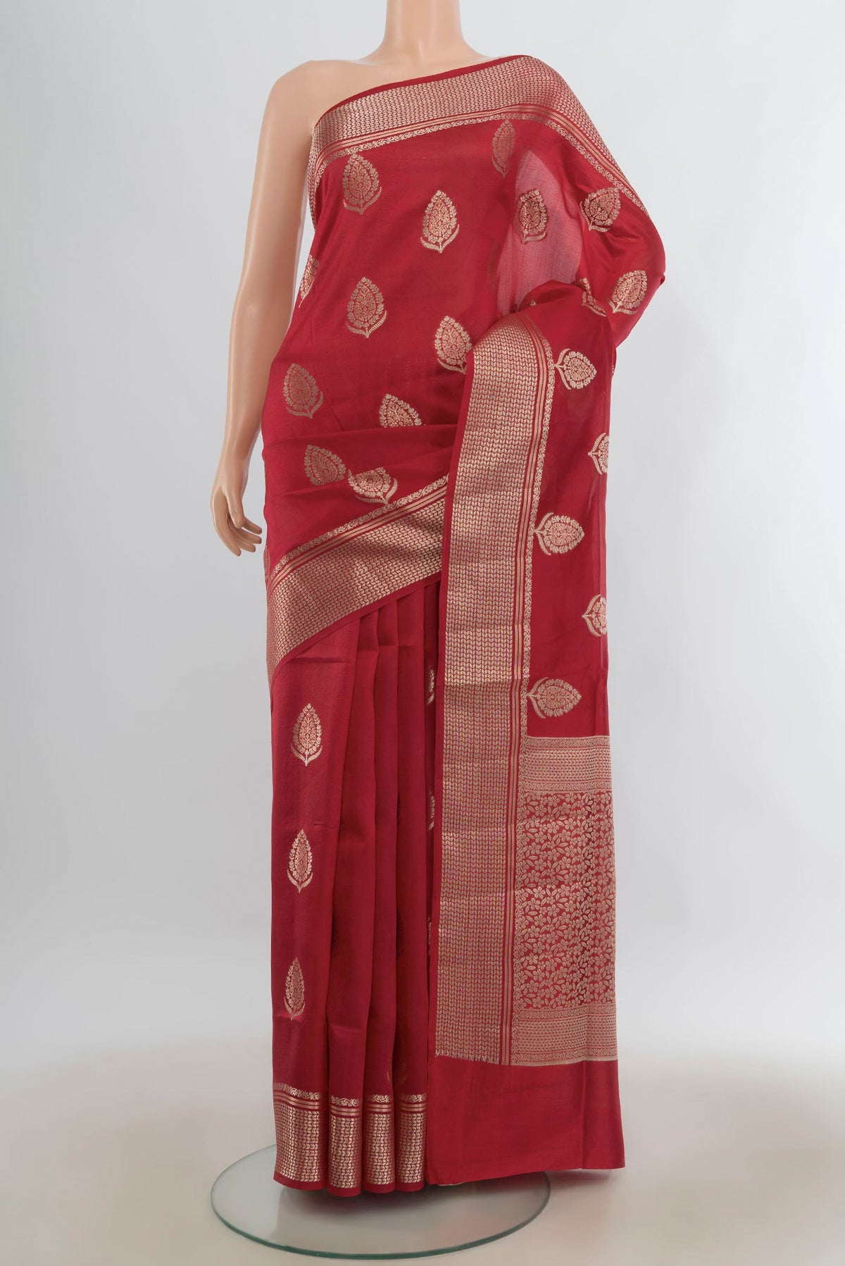 Pure Silk Red Banarasi Raw Saree with Zari Butta on the body and Zari Border.  displayed on a mannequin