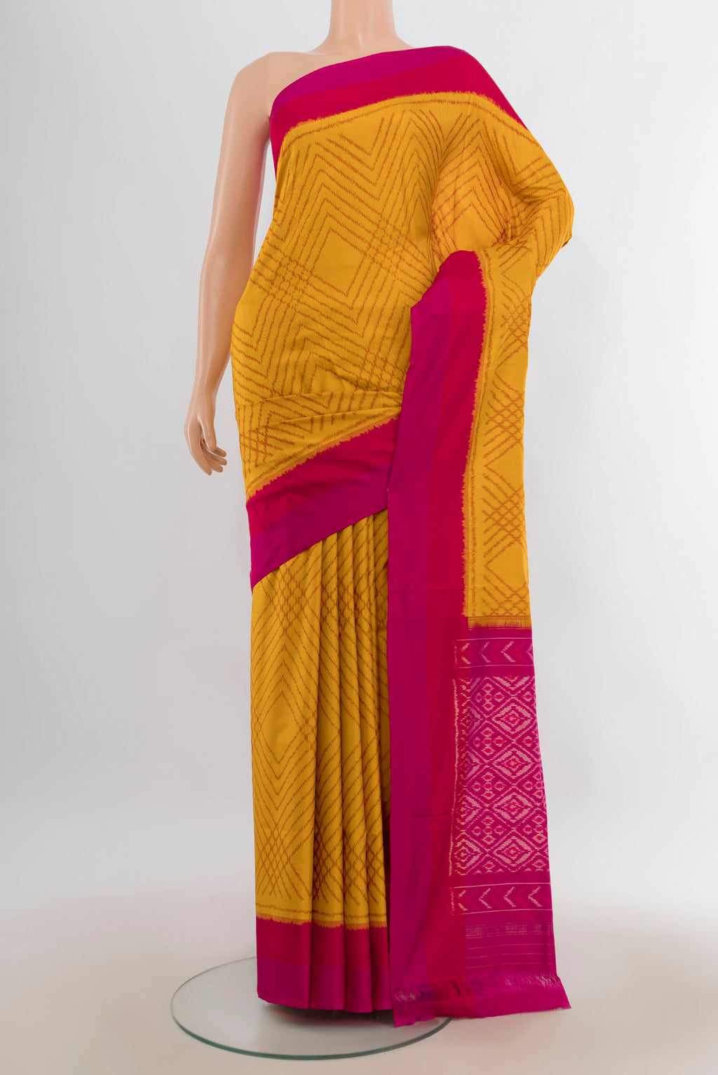 Pure Silk Mustard Pochampally Saree with Pure Ikat on the body and Plain Border.  displayed on a mannequin