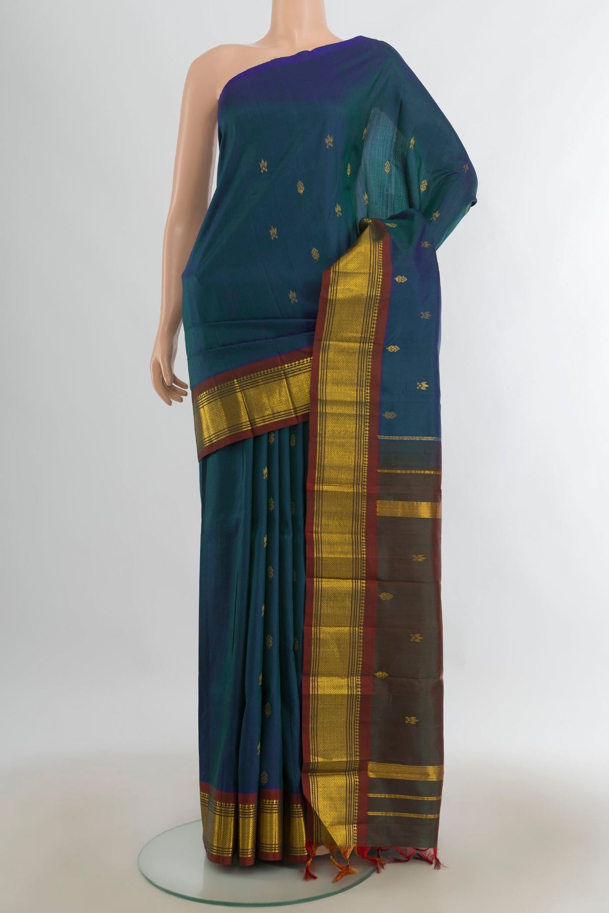 Pure Silk Peacock Blue Kanjivaram Saree with Zari Butta on the body and Silk Border.  displayed on a mannequin