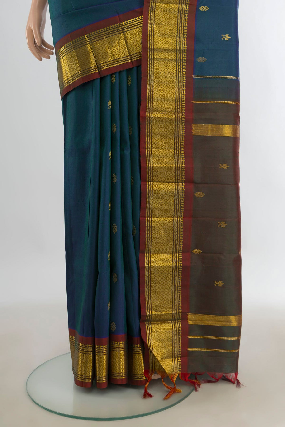 Pleats and pallu of Pure Silk Peacock Blue Kanjivaram Saree with Zari Butta on the body and Silk Border. 