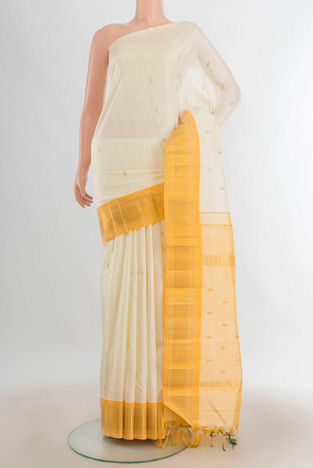 Pure Silk Cream Kanjivaram Saree with Zari Butta on the body and Silk Border.  displayed on a mannequin