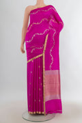 Pure Silk Rani Pink Banarasi Katan Saree with Zari Butta on the body and Zari Border.  displayed on a mannequin
