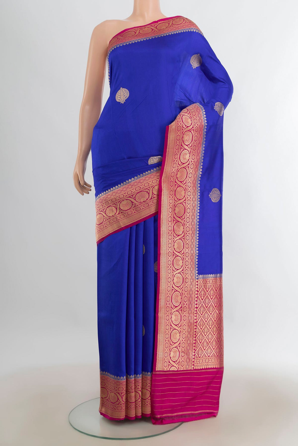 Pure Silk Dark Blue Banarasi Katan Saree with Zari Butta on the body and Silk Border.  displayed on a mannequin