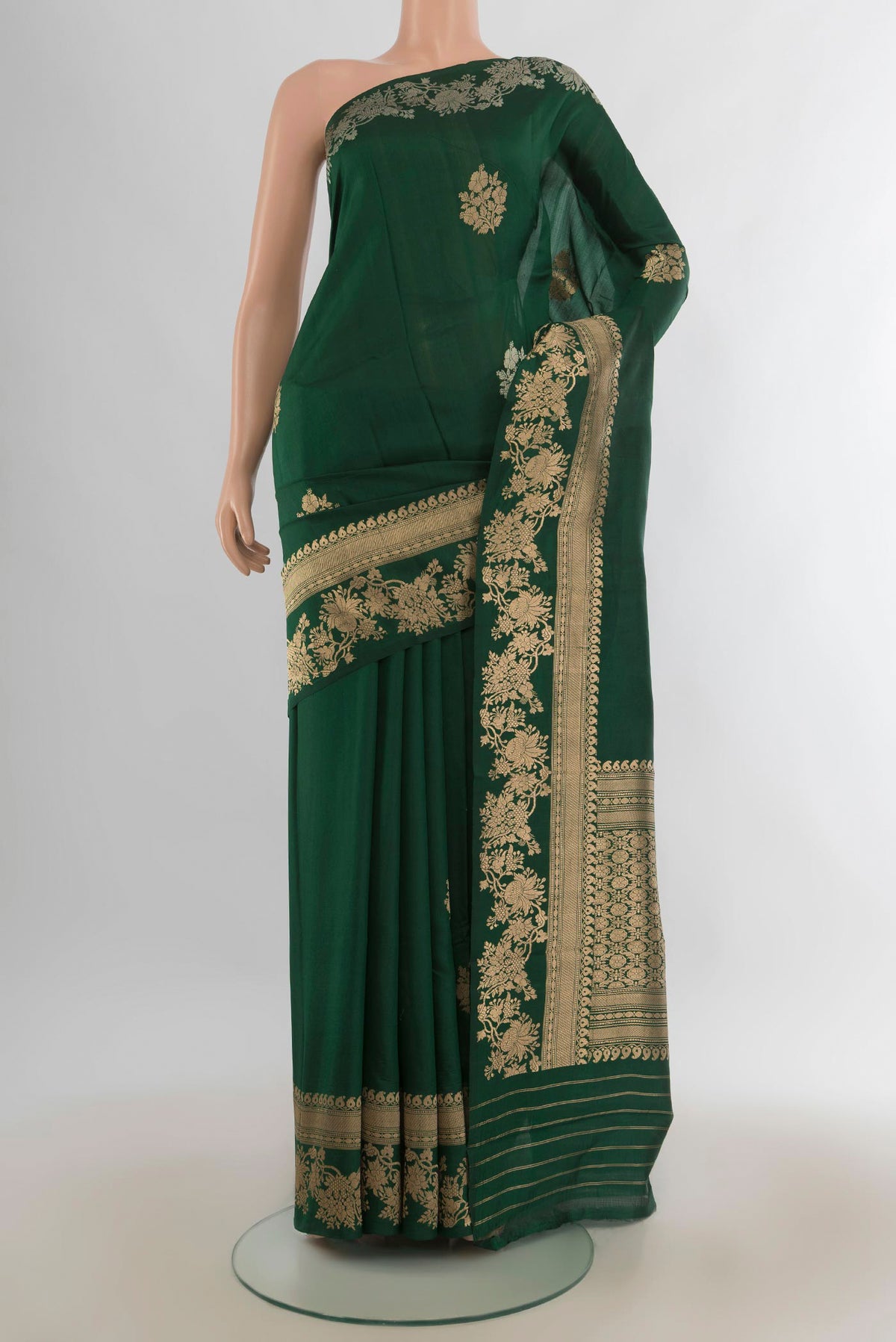 Pure Silk Bottle Green Banarasi Katan Saree with Zari Butta on the body and Zari Border.  displayed on a mannequin