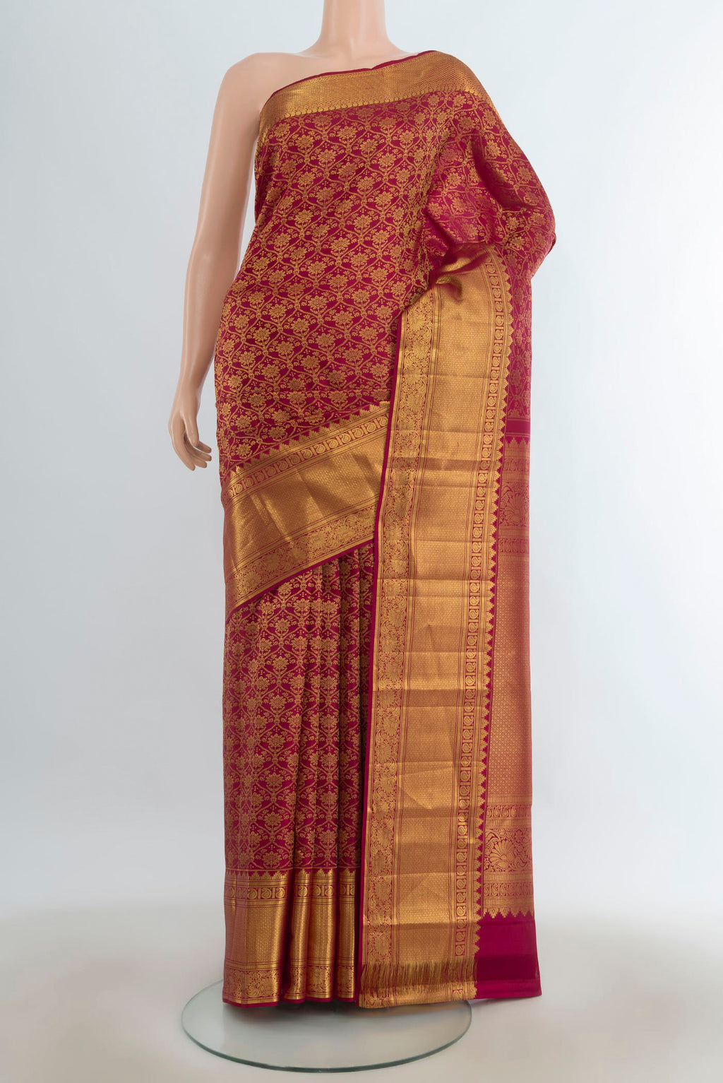 Pure Silk Maroon Kanchipuram Saree with Zari Butta on the body and Silk Border.  displayed on a mannequin