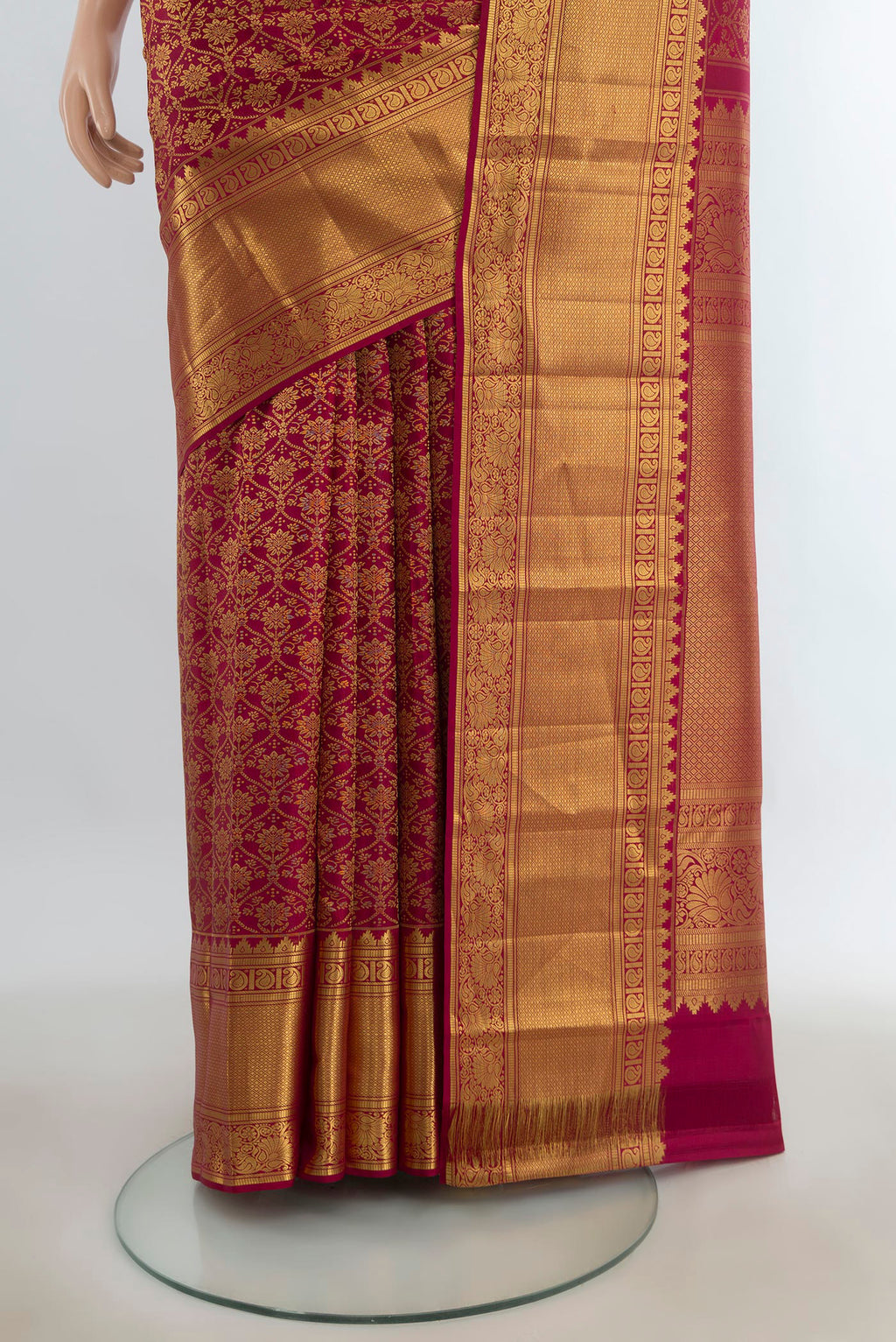 Pleats and pallu of Pure Silk Maroon Kanchipuram Saree with Zari Butta on the body and Silk Border. 