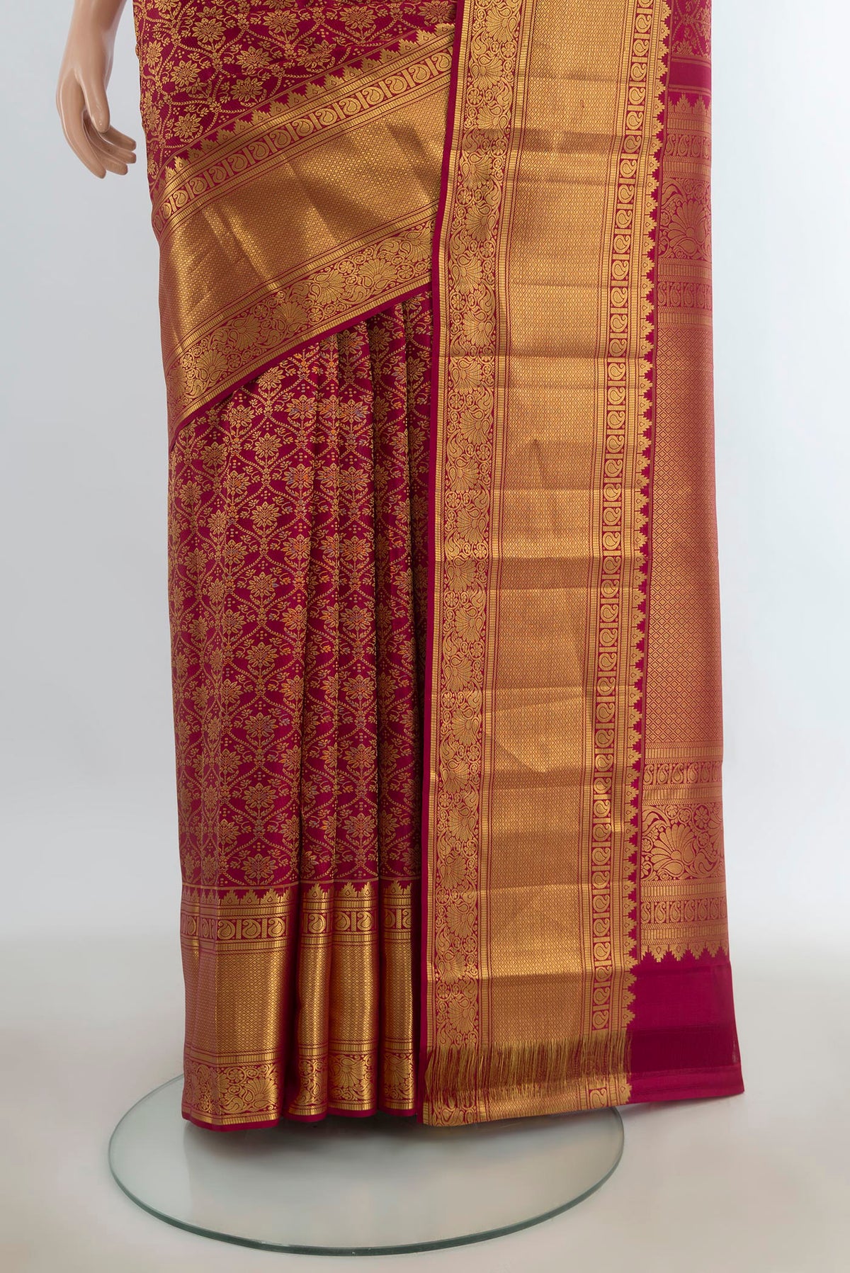 Pleats and pallu of Pure Silk Maroon Kanchipuram Saree with Zari Butta on the body and Silk Border. 