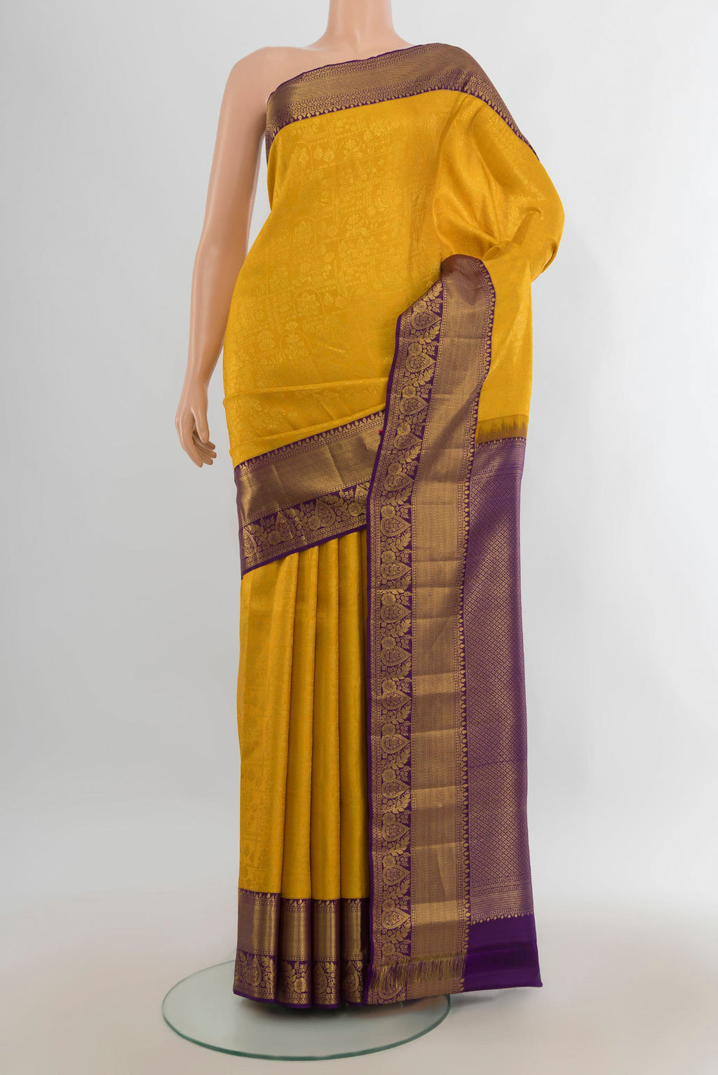 Pure Silk Yellow Kanjivaram Saree with Zari Butta on the body and Silk Border.  displayed on a mannequin