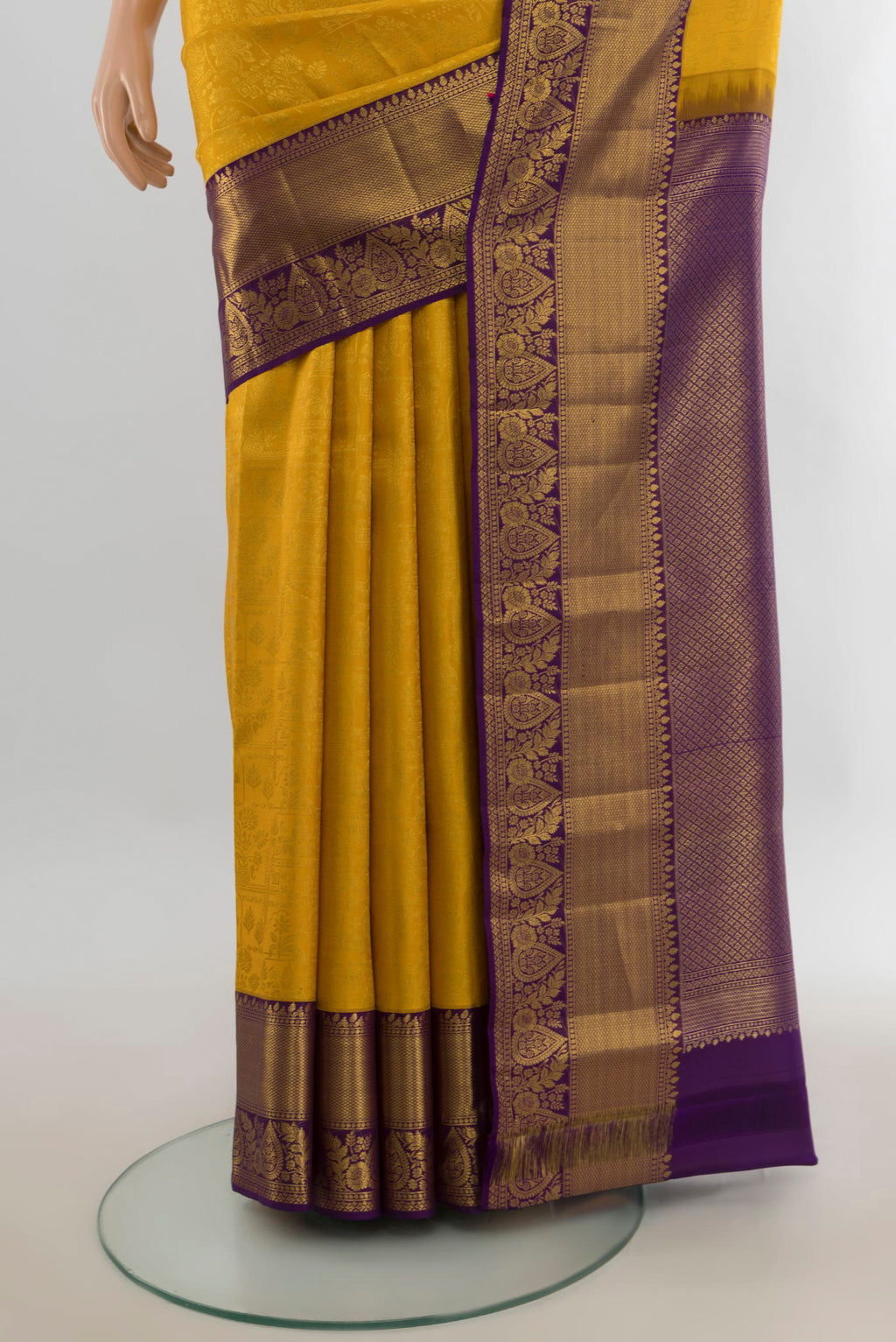 Pleats and pallu of Pure Silk Yellow Kanjivaram Saree with Zari Butta on the body and Silk Border. 