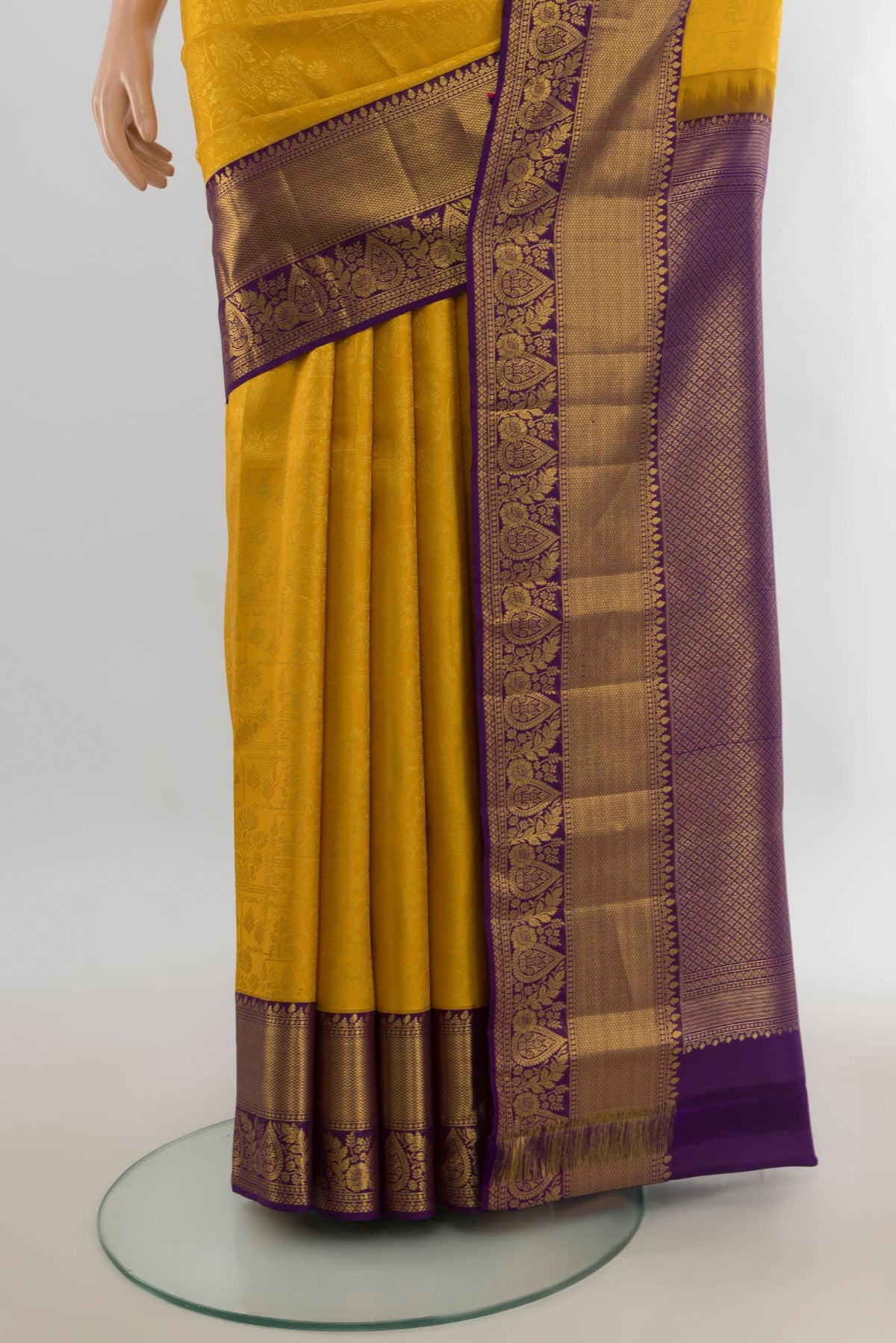 Pleats and pallu of Pure Silk Yellow Kanjivaram Saree with Zari Butta on the body and Silk Border. 