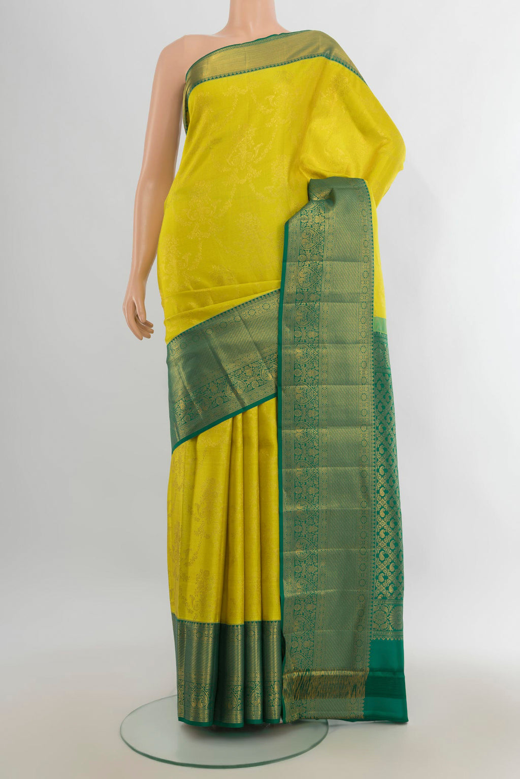 Pure Silk Light Green Kanjivaram Saree with Zari Butta on the body and Silk Border.  displayed on a mannequin