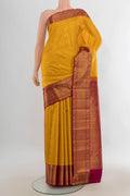 Pure Silk Yellow Kanjivaram Saree with Zari Butta on the body and Silk Border.  displayed on a mannequin