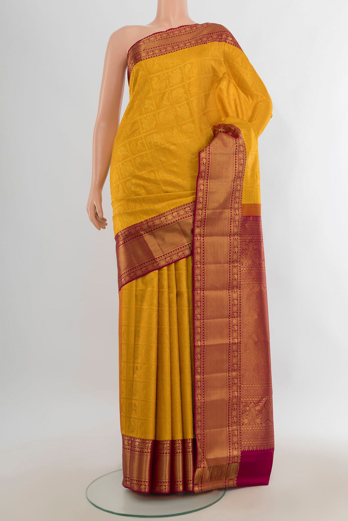 Pure Silk Yellow Kanjivaram Saree with Zari Butta on the body and Silk Border.  displayed on a mannequin