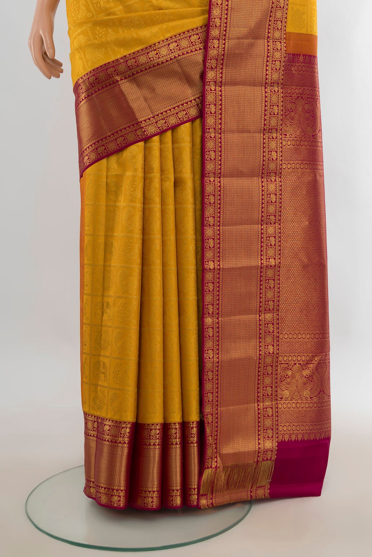 Pleats and pallu of Pure Silk Yellow Kanjivaram Saree with Zari Butta on the body and Silk Border. 