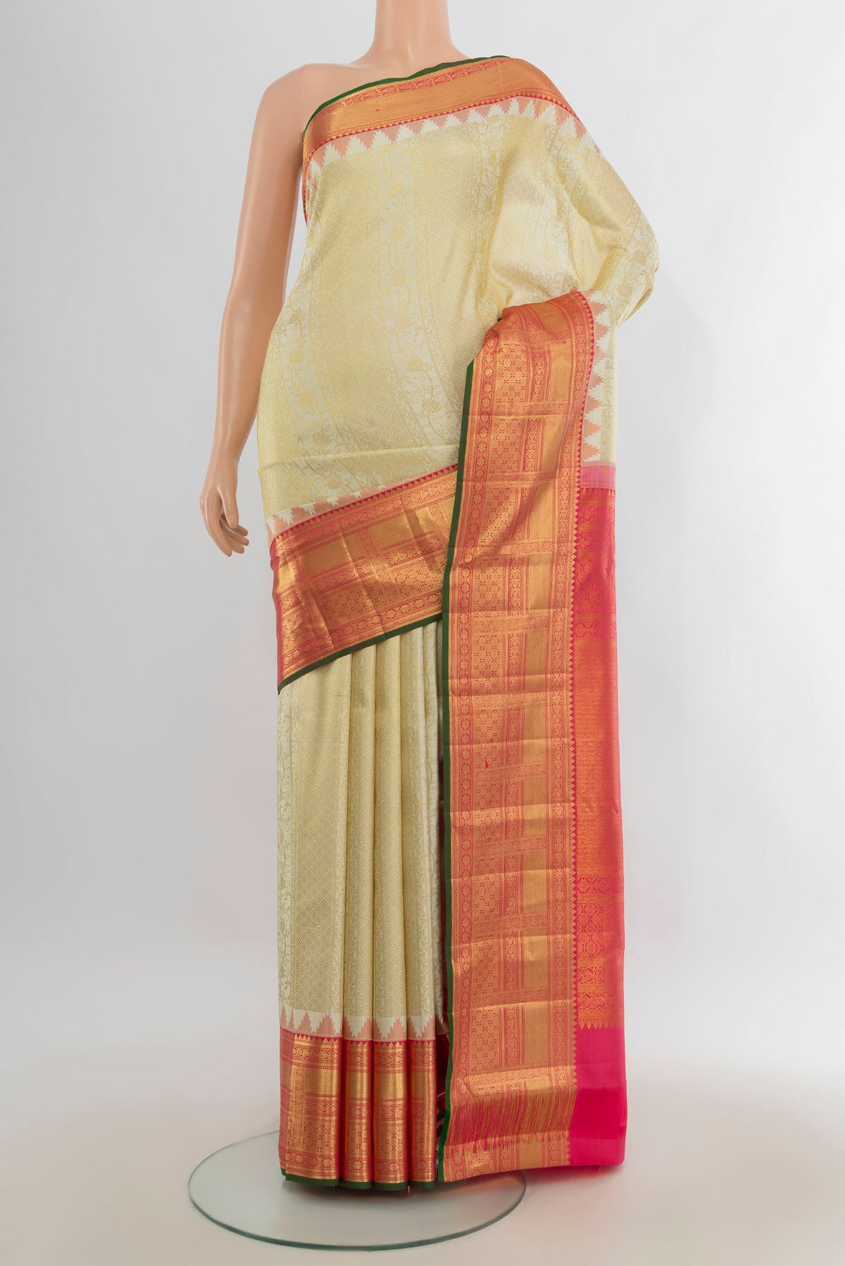 Pure Silk Golden Kanjivaram Saree with Zari Butta on the body and Silk Border.  displayed on a mannequin