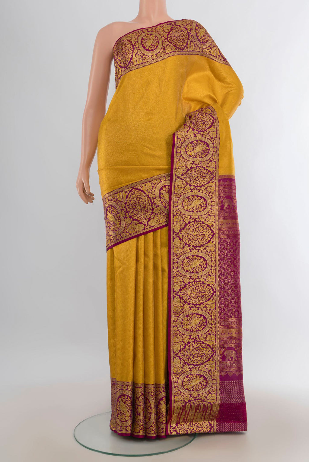 Pure Silk Yellow Kanjivaram Saree with Zari Butta on the body and Silk Border.  displayed on a mannequin