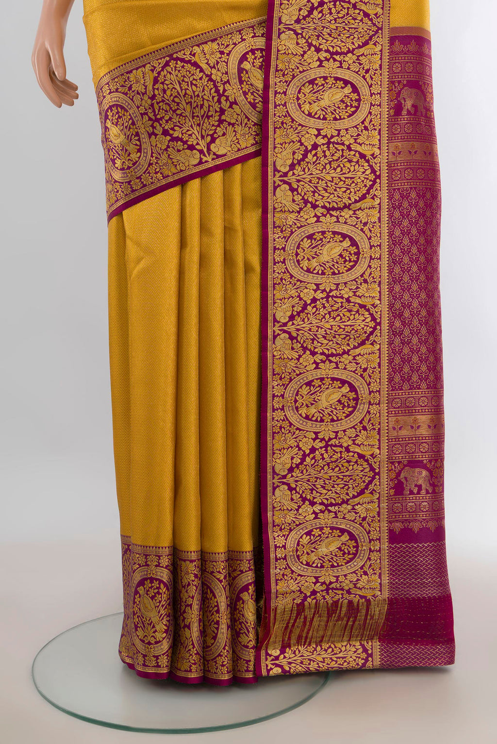 Pleats and pallu of Pure Silk Yellow Kanjivaram Saree with Zari Butta on the body and Silk Border. 