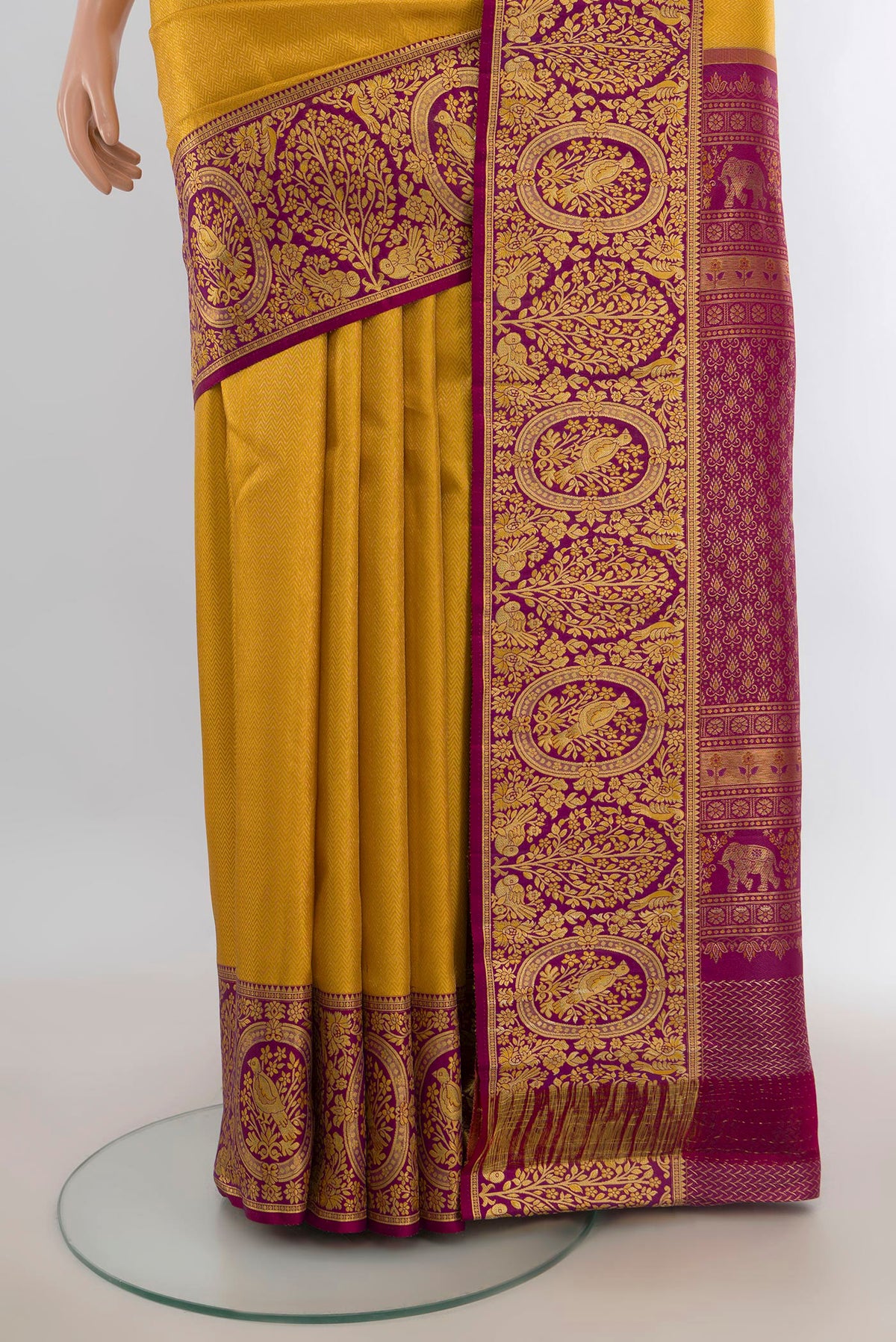 Pleats and pallu of Pure Silk Yellow Kanjivaram Saree with Zari Butta on the body and Silk Border. 
