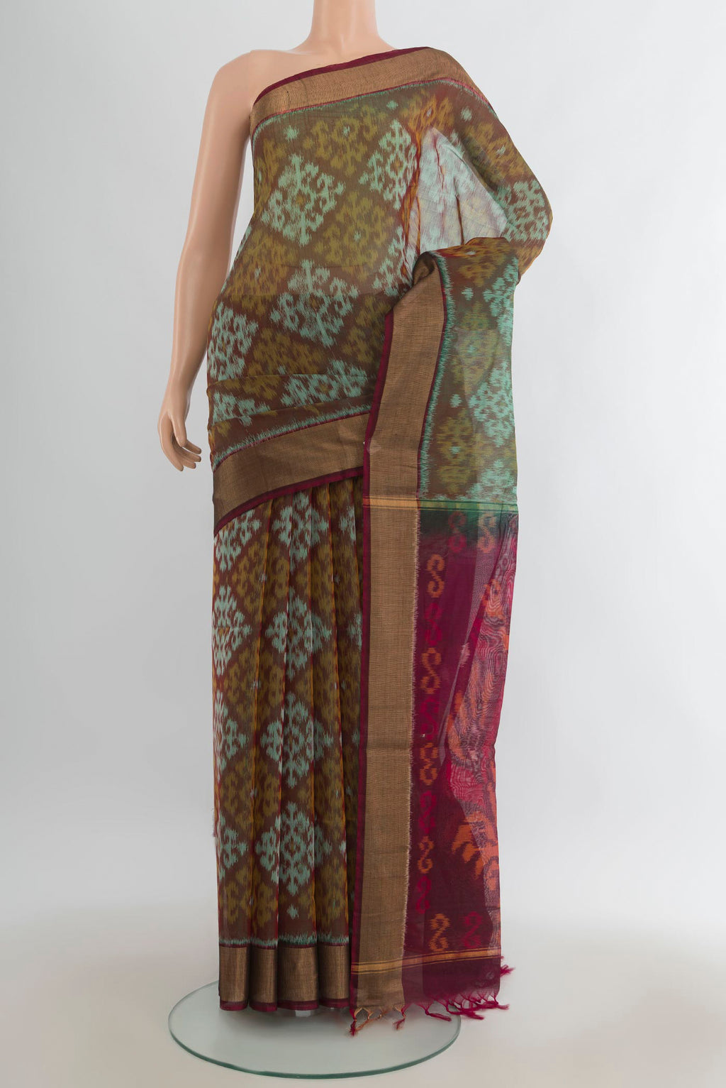 Green Silk Cotton Saree with Ikat Print on the body and Zari Border.  displayed on a mannequin
