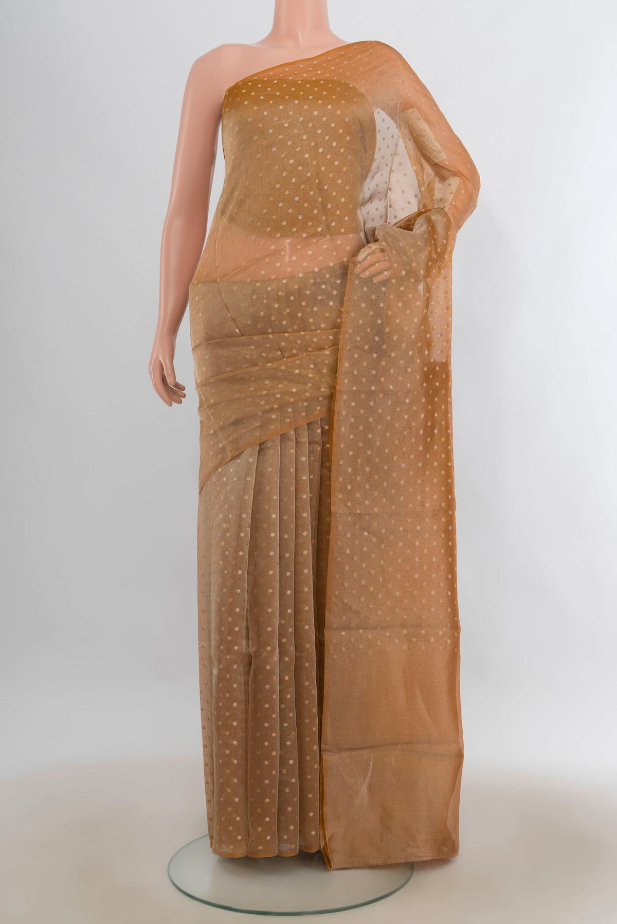 Golden Organza Saree with Zari Butta on the body and Without Border.  displayed on a mannequin