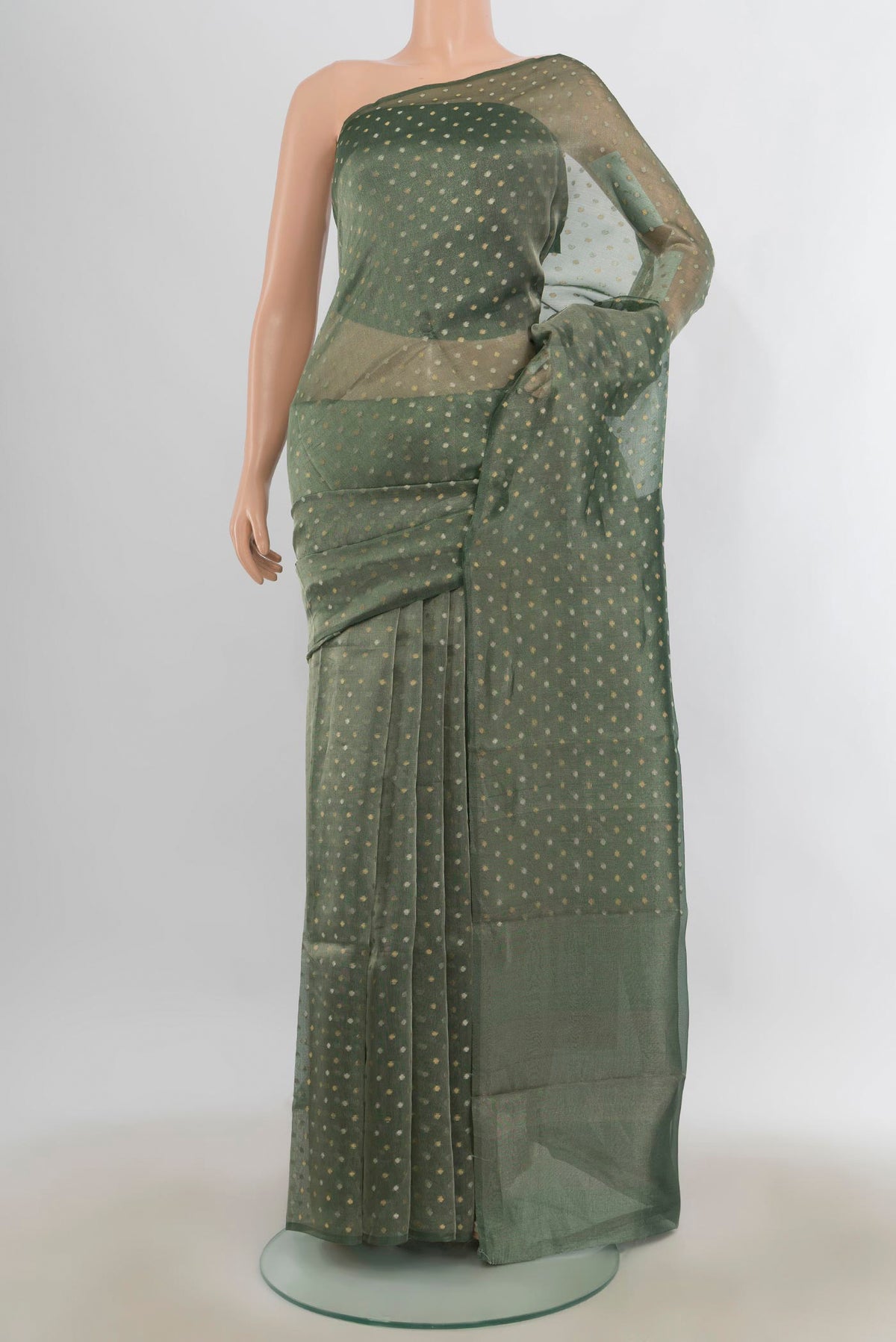 Green Organza Saree with Zari Butta on the body and Without Border.  displayed on a mannequin