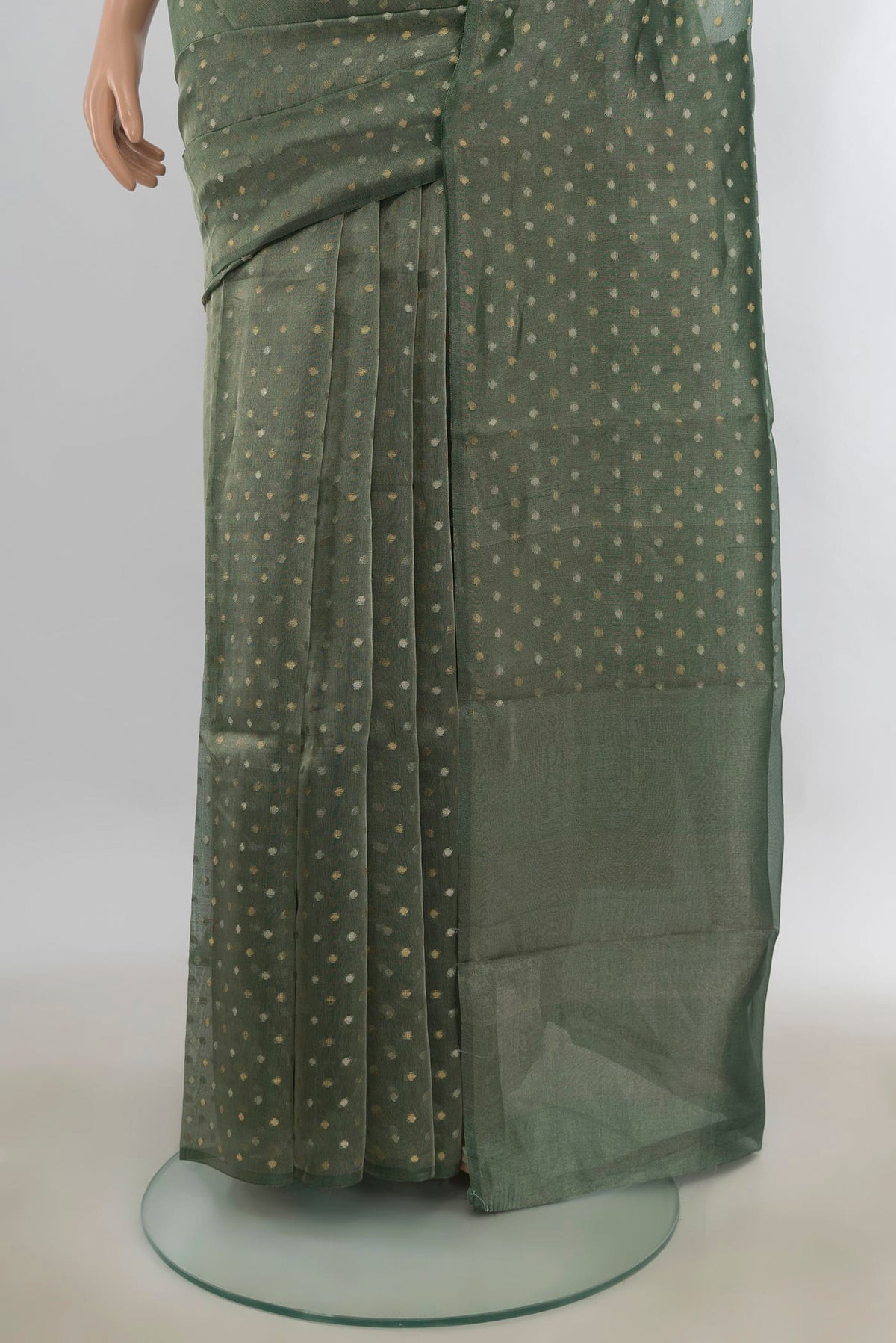 Pleats and pallu of Green Organza Saree with Zari Butta on the body and Without Border. 
