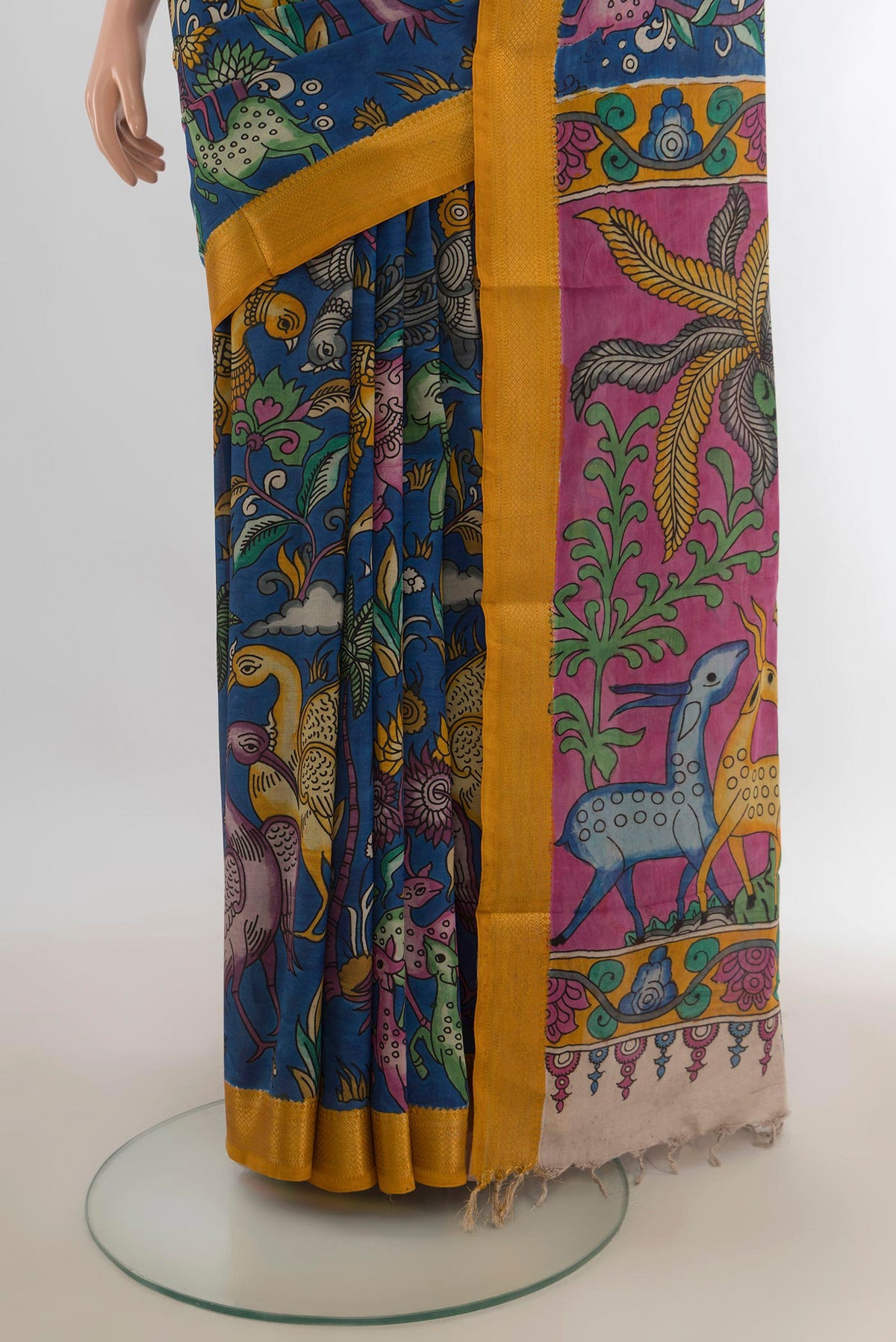 Pleats and pallu of Pure Silk Blue kalamkari Saree with Floral Print on the body and Zari Border. 