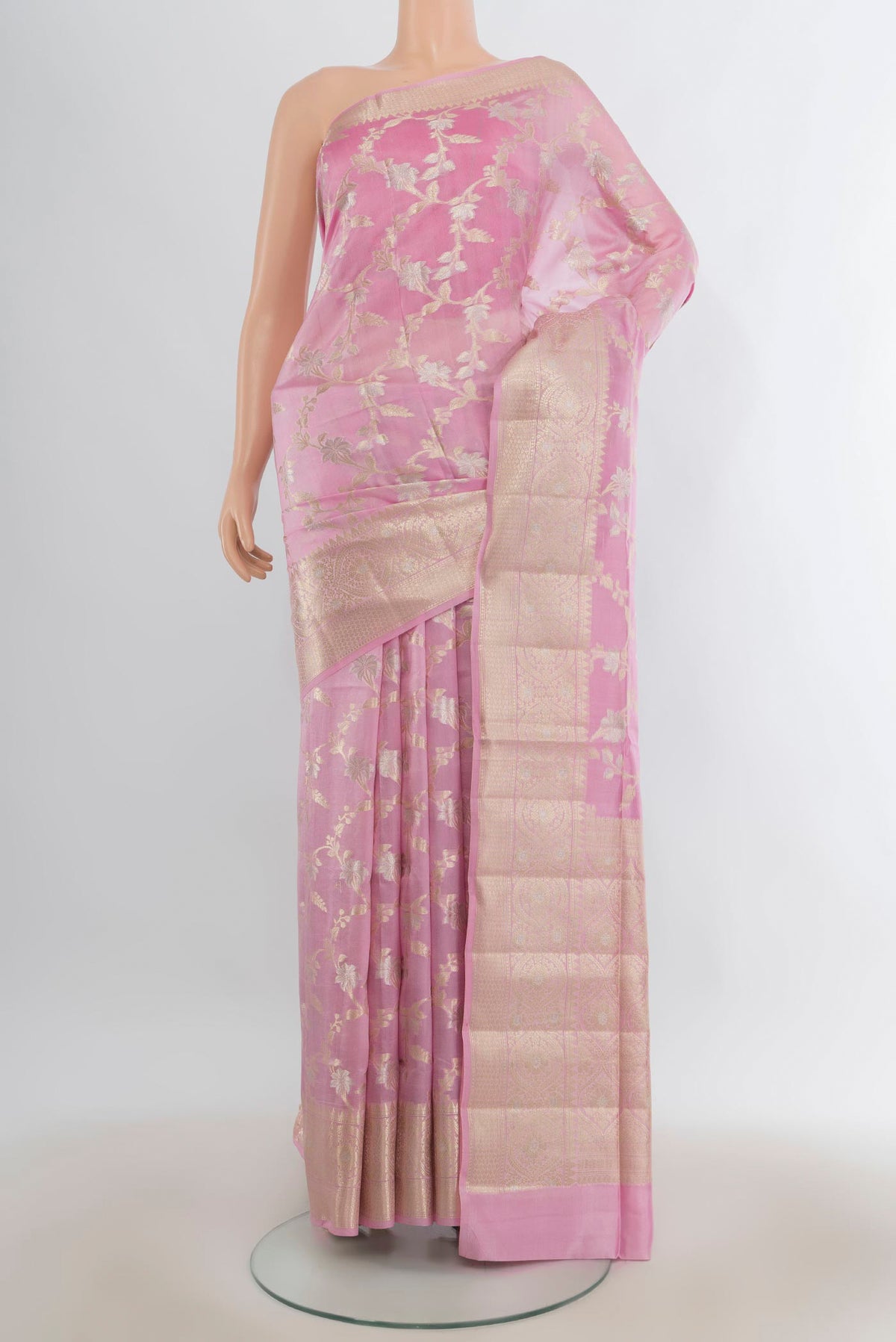 Pure Silk Rose pink Banarasi Raw Saree with Zari Butta on the body and Zari Border.  displayed on a mannequin
