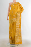 Pure Silk Mustard Banarasi Raw Saree with Zari Butta on the body and Silk Border.  displayed on a mannequin