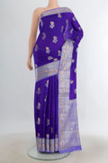 Pure Silk Dark Blue Banarasi Raw Saree with Zari Butta on the body and Silk Border.  displayed on a mannequin