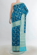 Pure Silk Peacock Blue Banarasi Raw Saree with Zari Butta on the body and Silk Border.  displayed on a mannequin