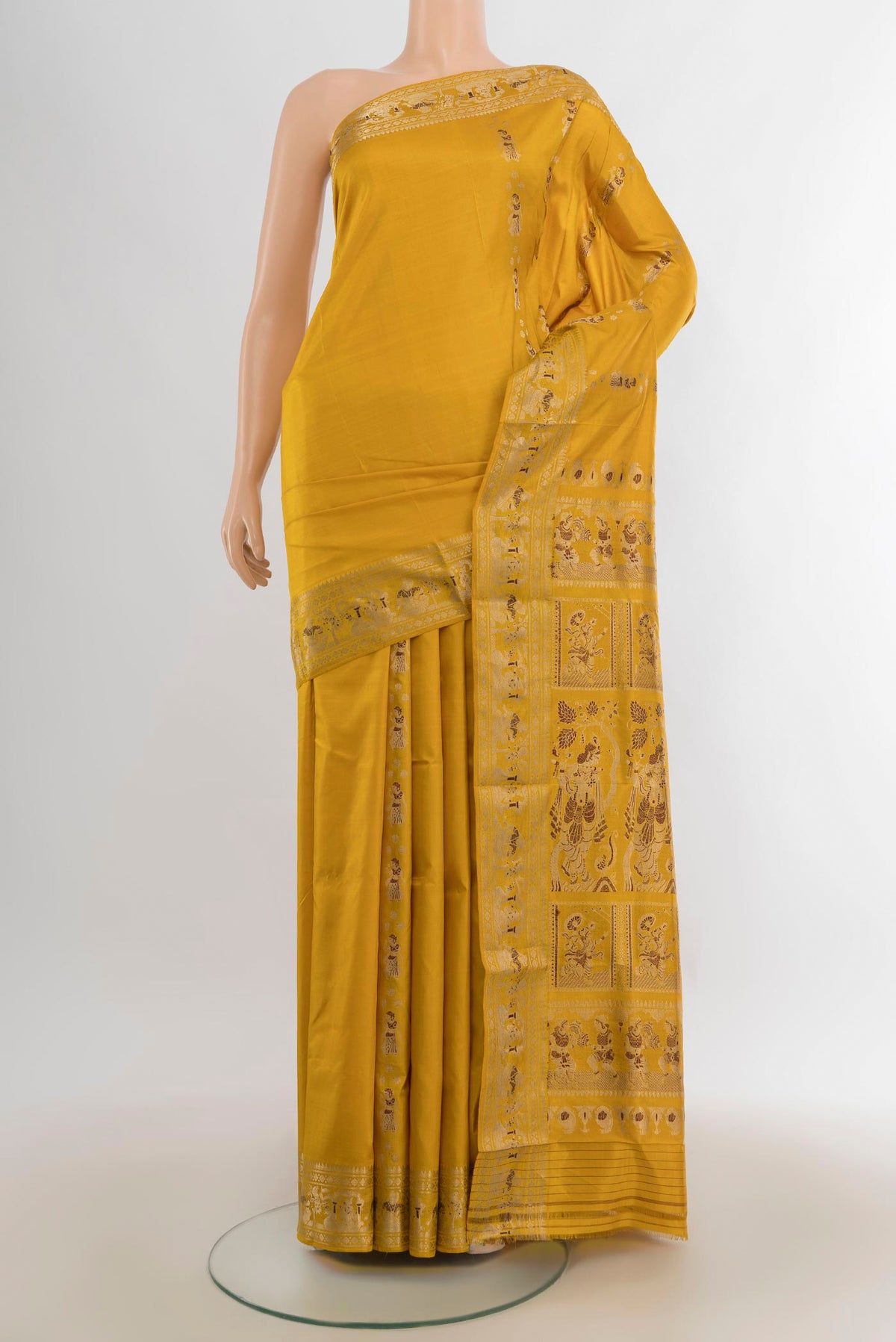 Pure Silk Mustard Baluchari Saree with Zari Butta on the body and Zari Border.  displayed on a mannequin