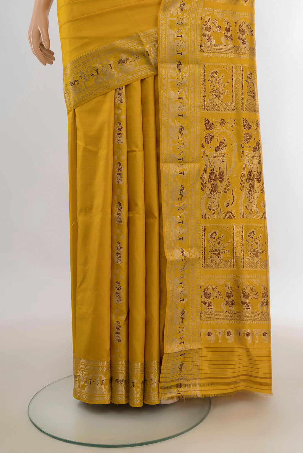 Pleats and pallu of Pure Silk Mustard Baluchari Saree with Zari Butta on the body and Zari Border. 