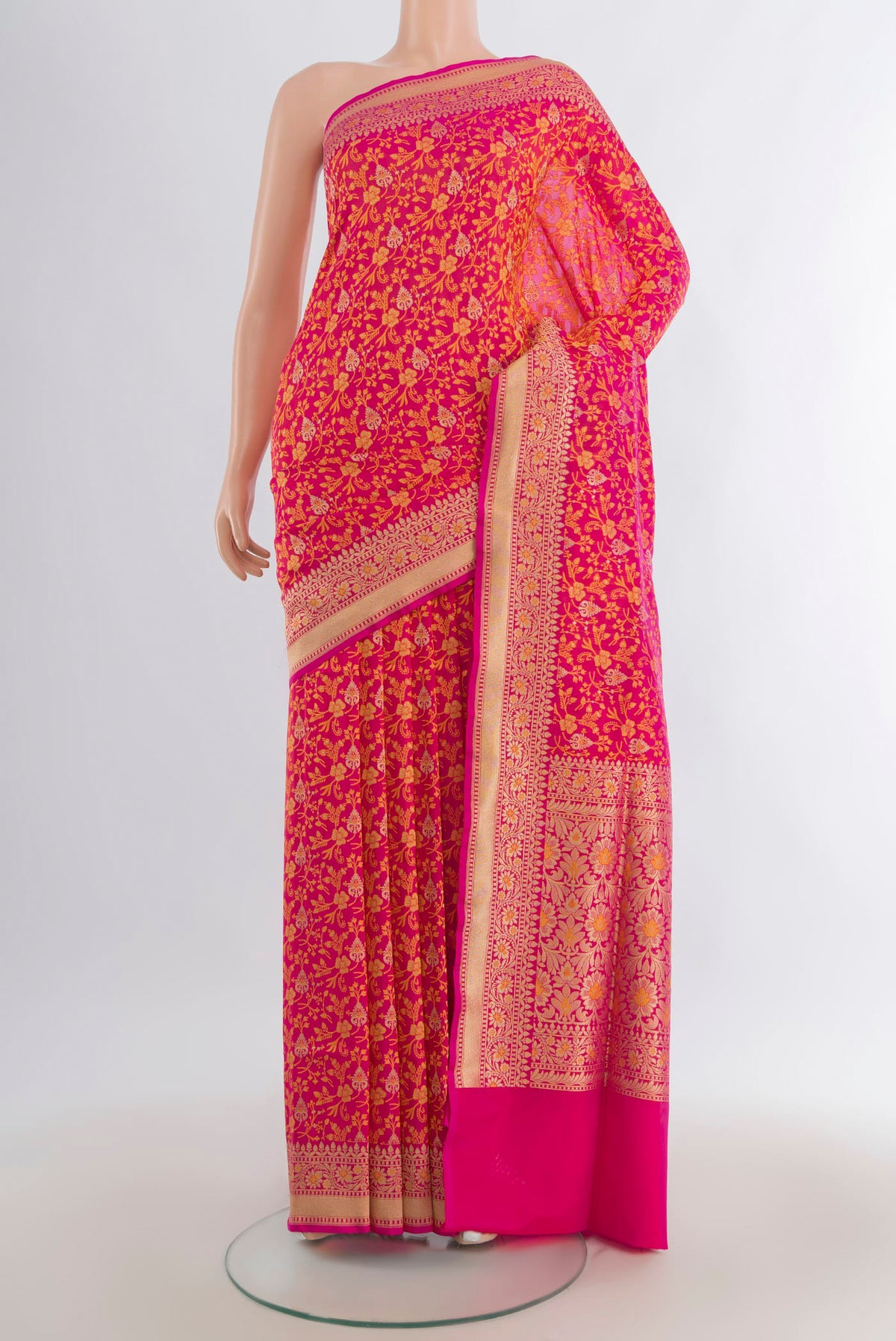Pure Silk Rani Pink Banarasi Saree with Jacquard design on the body and Zari Border.  displayed on a mannequin