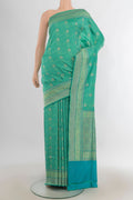 Pure Silk Green Banarasi Saree with Jacquard With Zari Butta on the body and Zari Border.  displayed on a mannequin