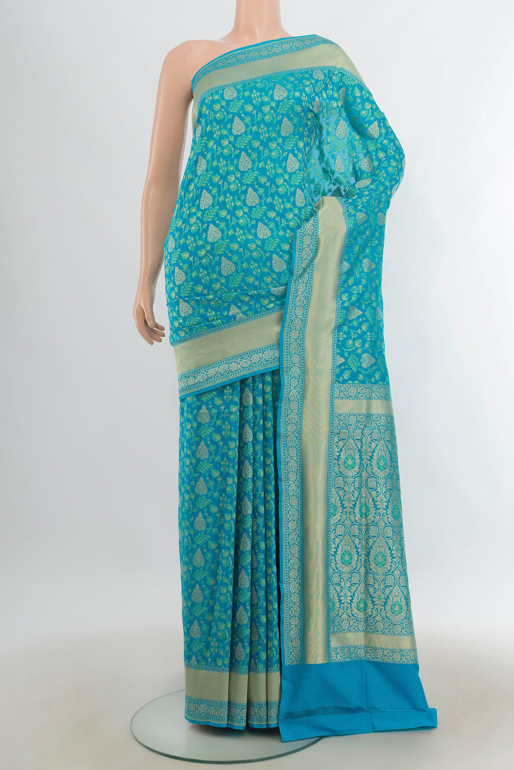 Pure Silk Light Blue Banarasi Saree with Zari Butta on the body and Silk Border.  displayed on a mannequin