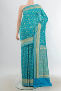 Pure Silk Light Blue Banarasi Saree with Zari Butta on the body and Silk Border.  displayed on a mannequin