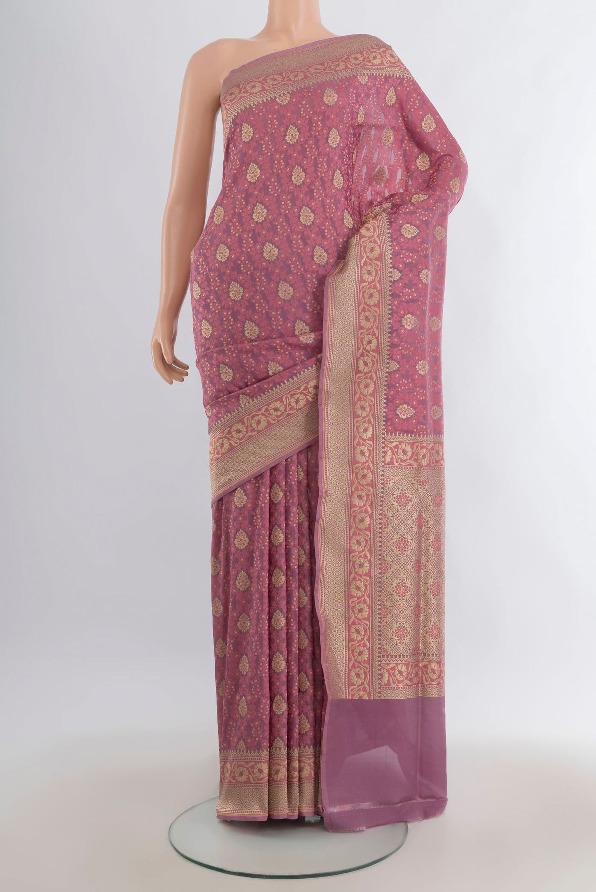 Pure Silk Rose Gold Banarasi Saree with Zari And Thread Butta on the body and Zari Border.  displayed on a mannequin