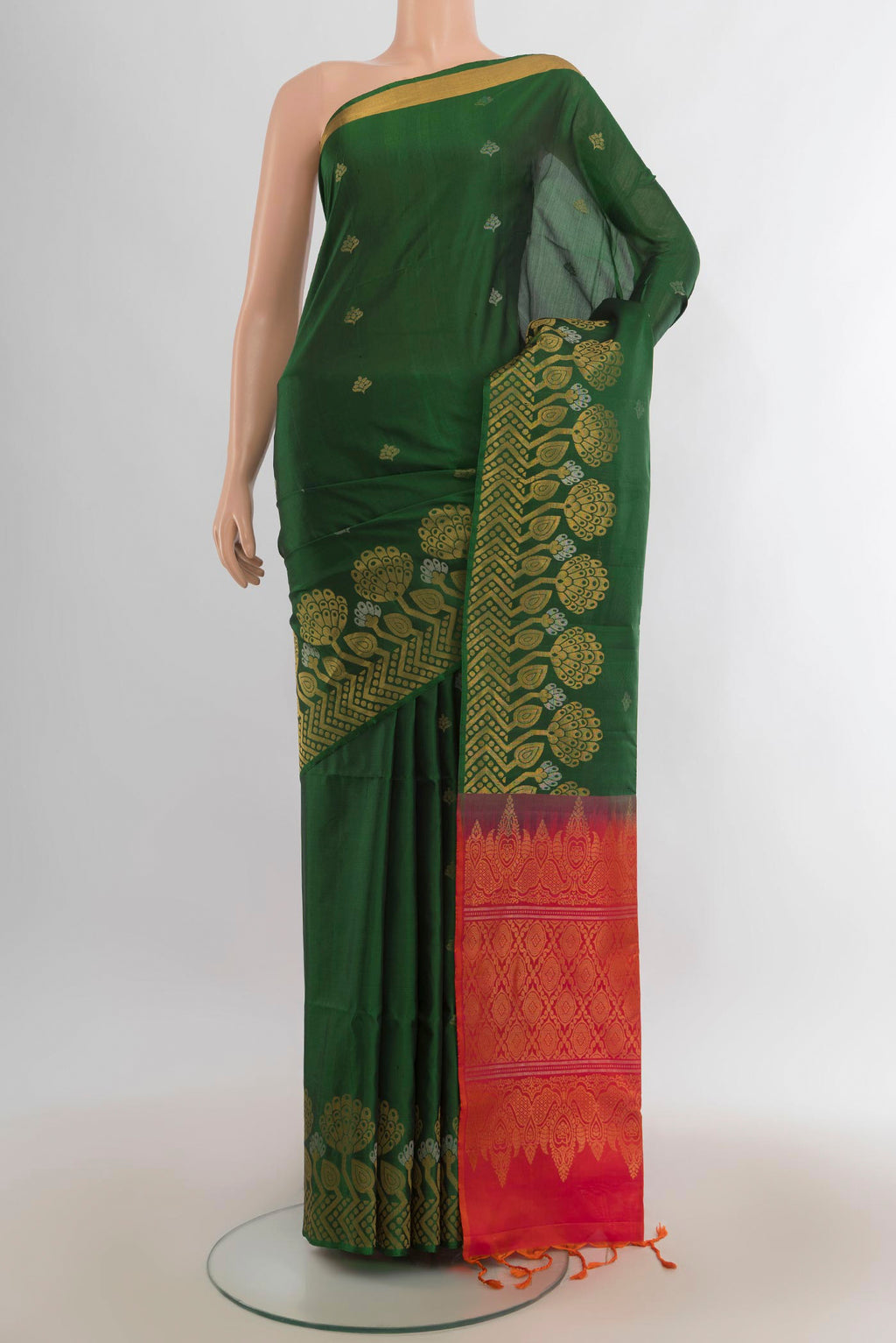 Pure Silk Bottle Green Soft Saree with Zari Butta on the body and Zari Border.  displayed on a mannequin