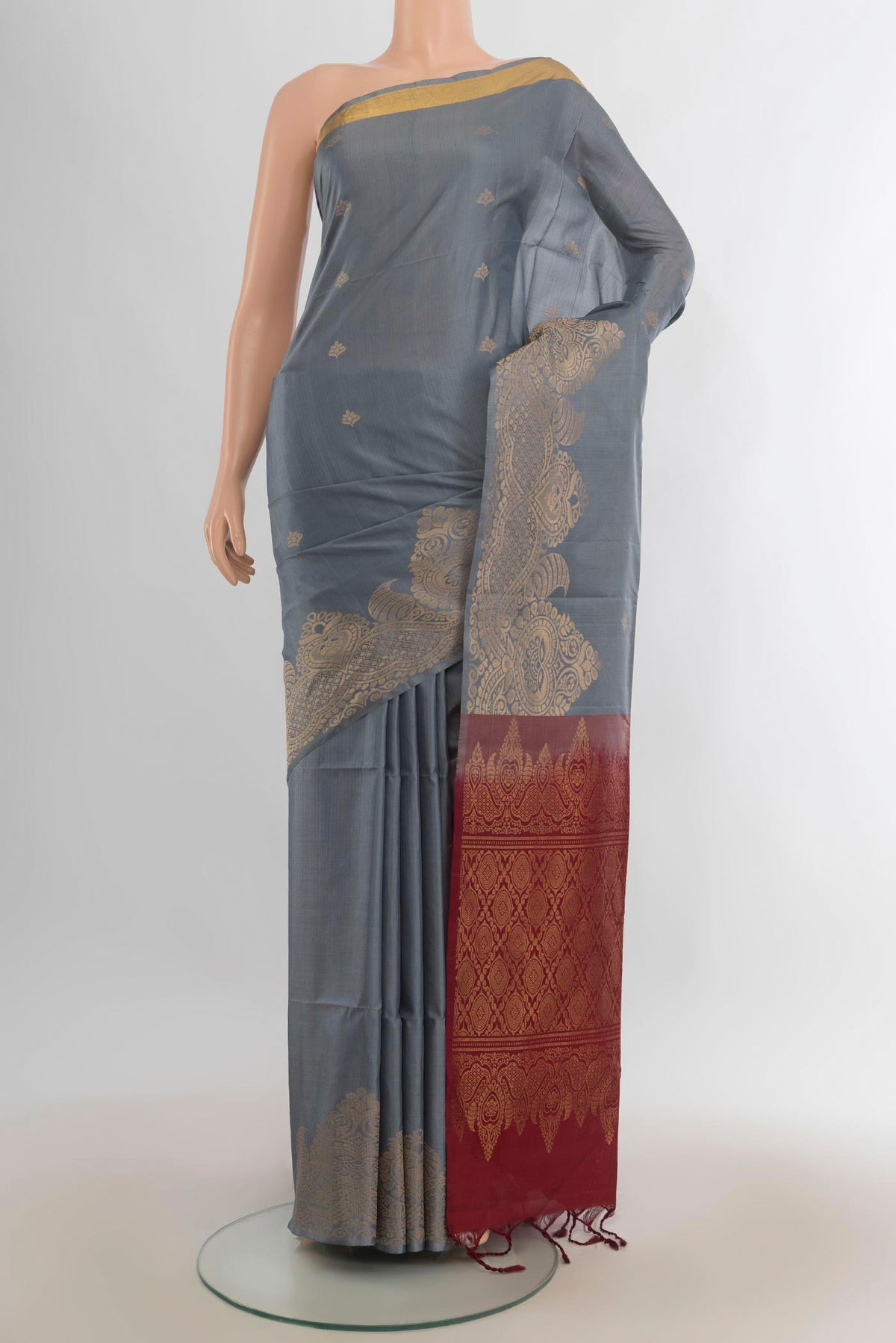 Pure Silk Grey Soft Saree with Zari Butta on the body and Fancy Border.  displayed on a mannequin