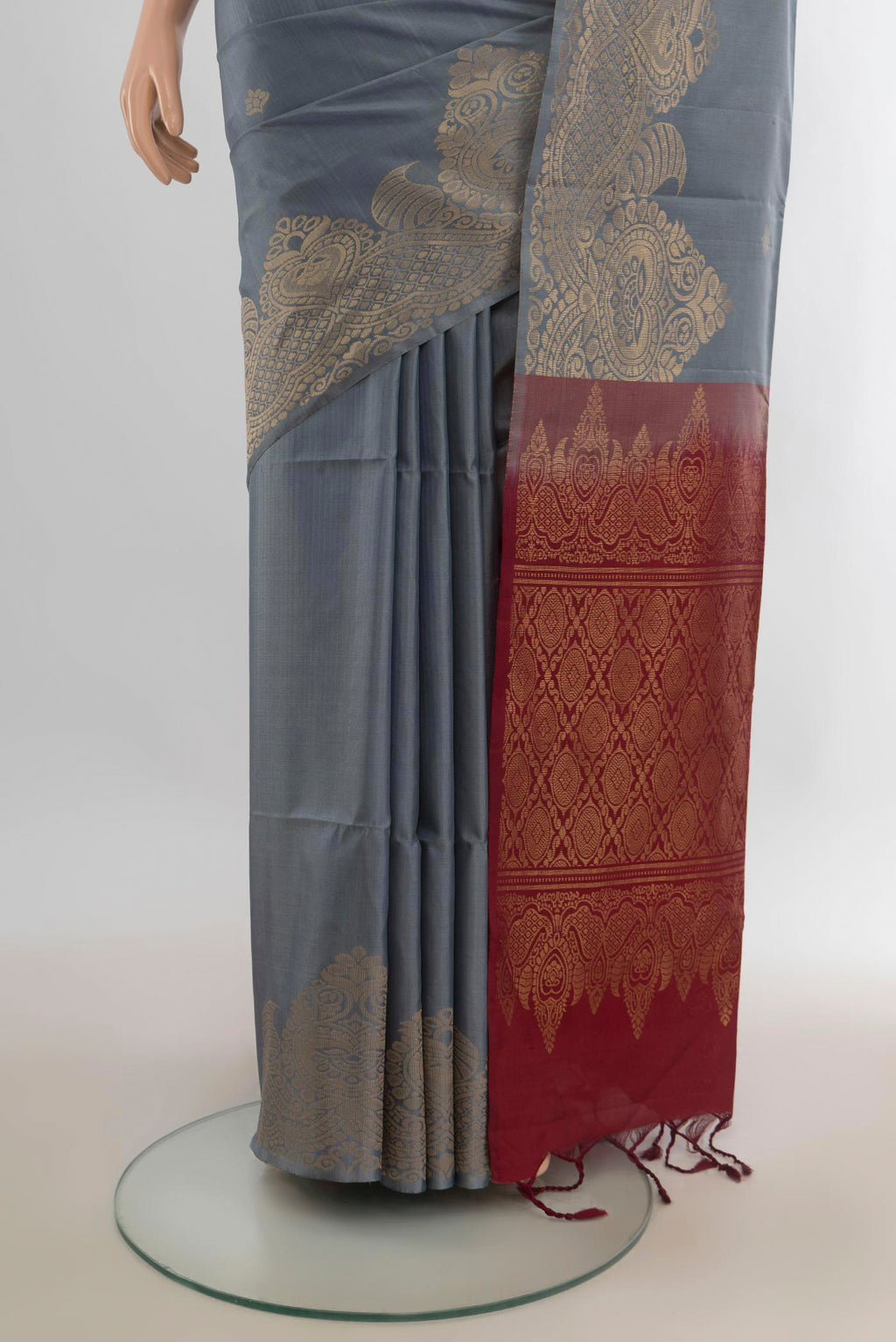 Pleats and pallu of Pure Silk Grey Soft Saree with Zari Butta on the body and Fancy Border. 