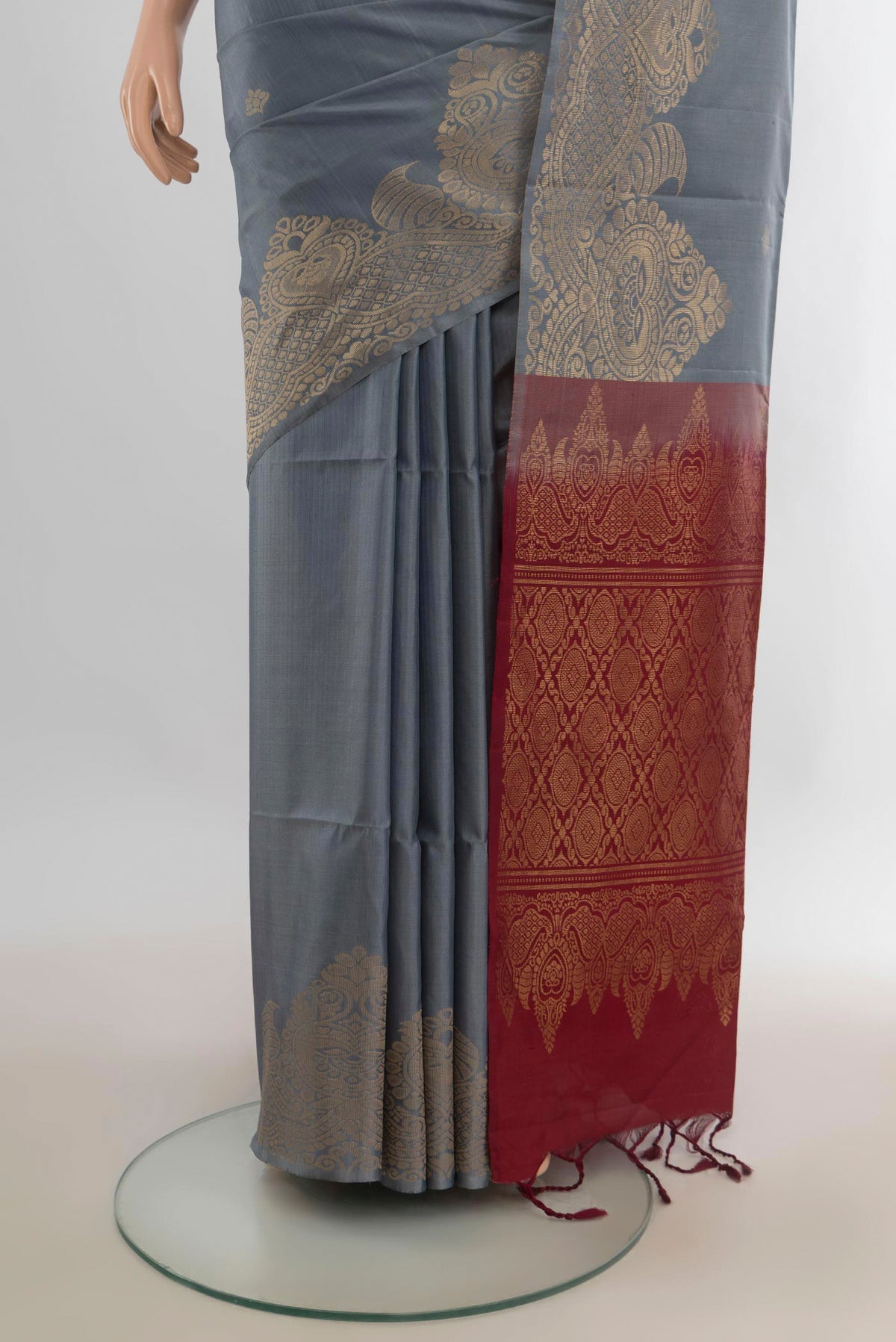 Pleats and pallu of Pure Silk Grey Soft Saree with Zari Butta on the body and Fancy Border. 