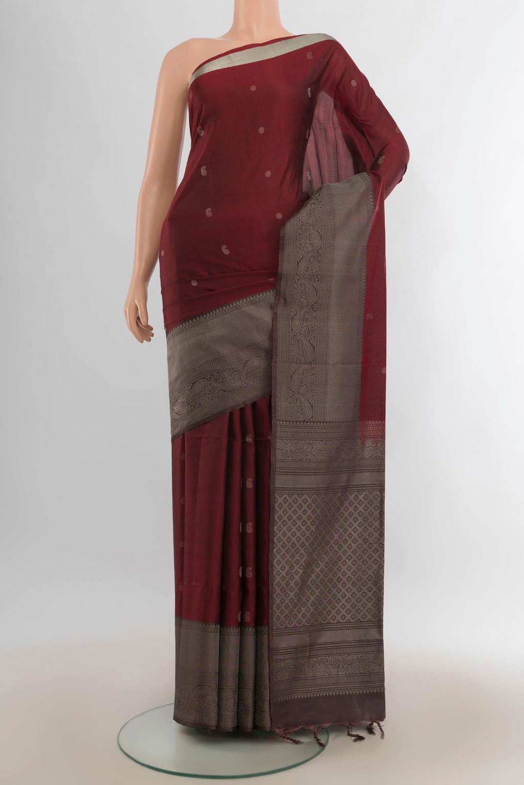 Pure Silk Rust Soft Saree with Zari Butta on the body and Fancy Border.  displayed on a mannequin