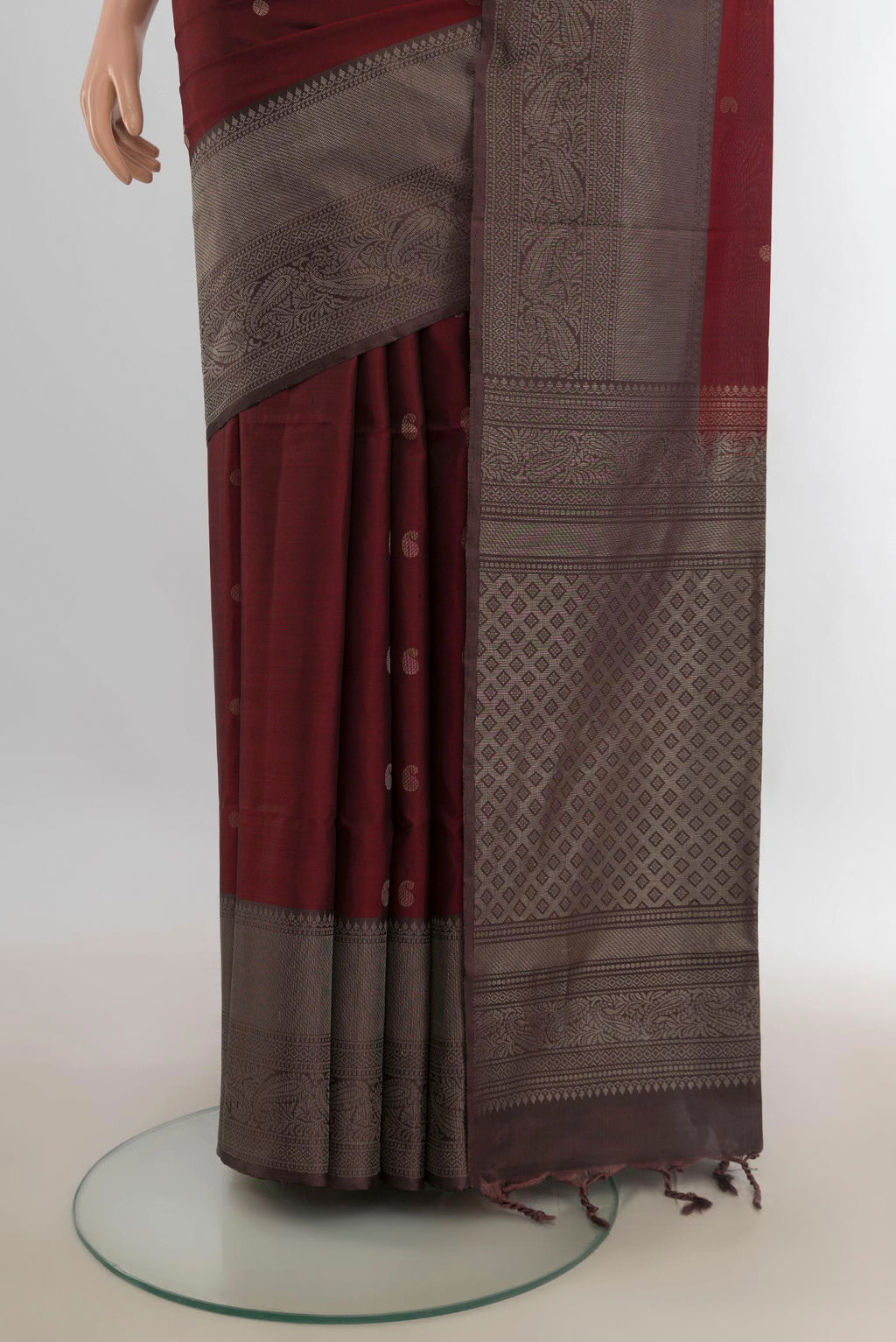 Pleats and pallu of Pure Silk Rust Soft Saree with Zari Butta on the body and Fancy Border. 