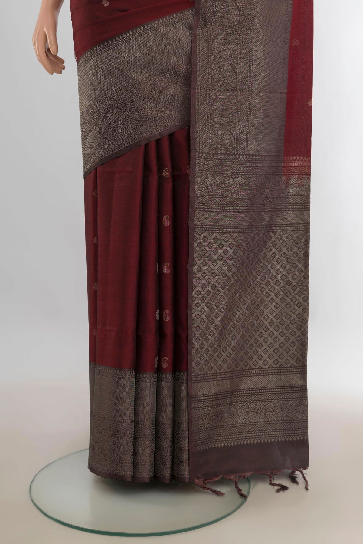 Pleats and pallu of Pure Silk Rust Soft Saree with Zari Butta on the body and Fancy Border. 