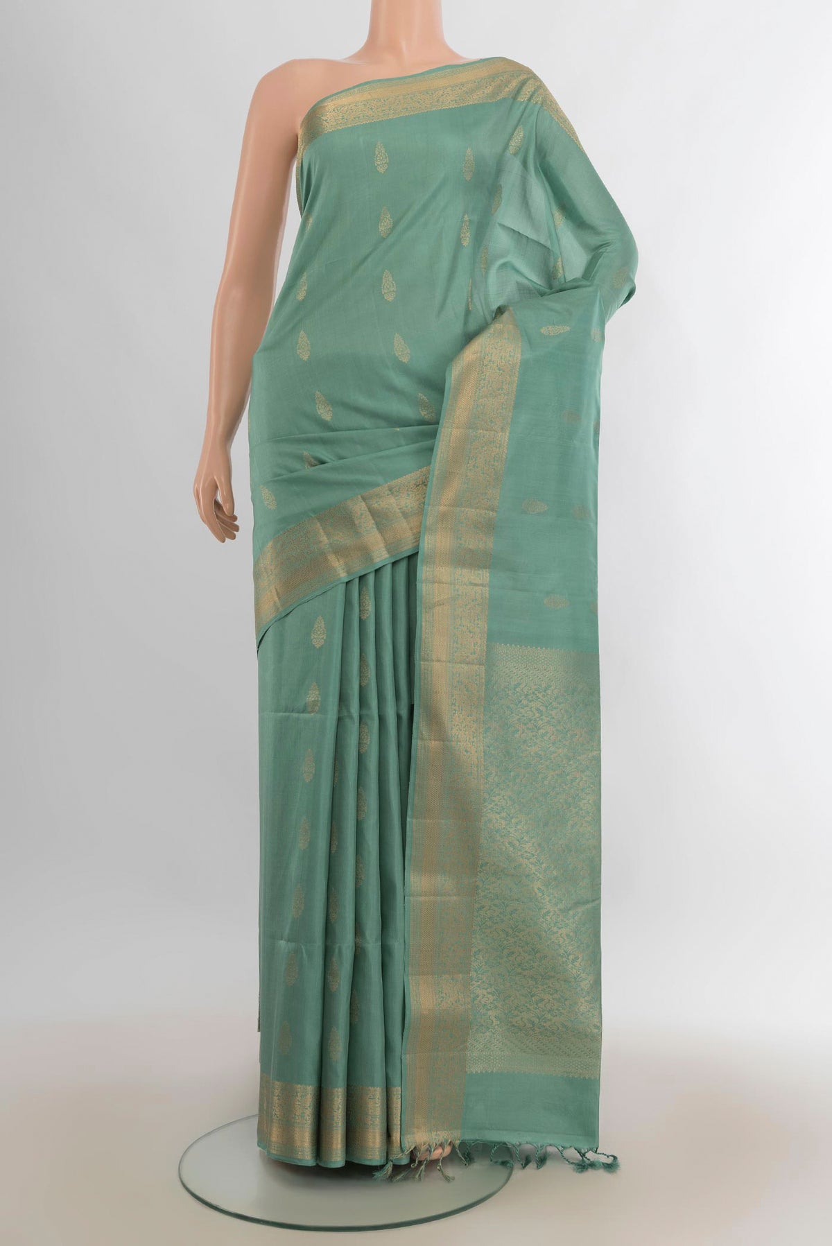 Pure Silk Pista Green Soft Saree with Zari Butta on the body and Zari Border.  displayed on a mannequin