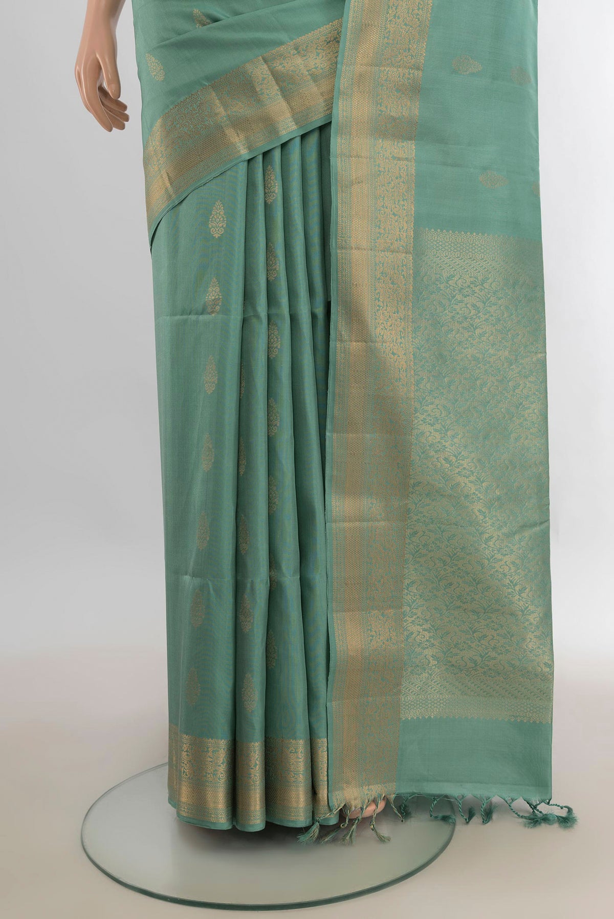 Pleats and pallu of Pure Silk Pista Green Soft Saree with Zari Butta on the body and Zari Border. 
