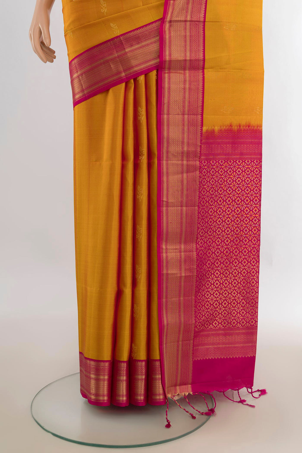Pleats and pallu of Pure Silk Mustard Soft Saree with Zari Butta on the body and Zari Border. 