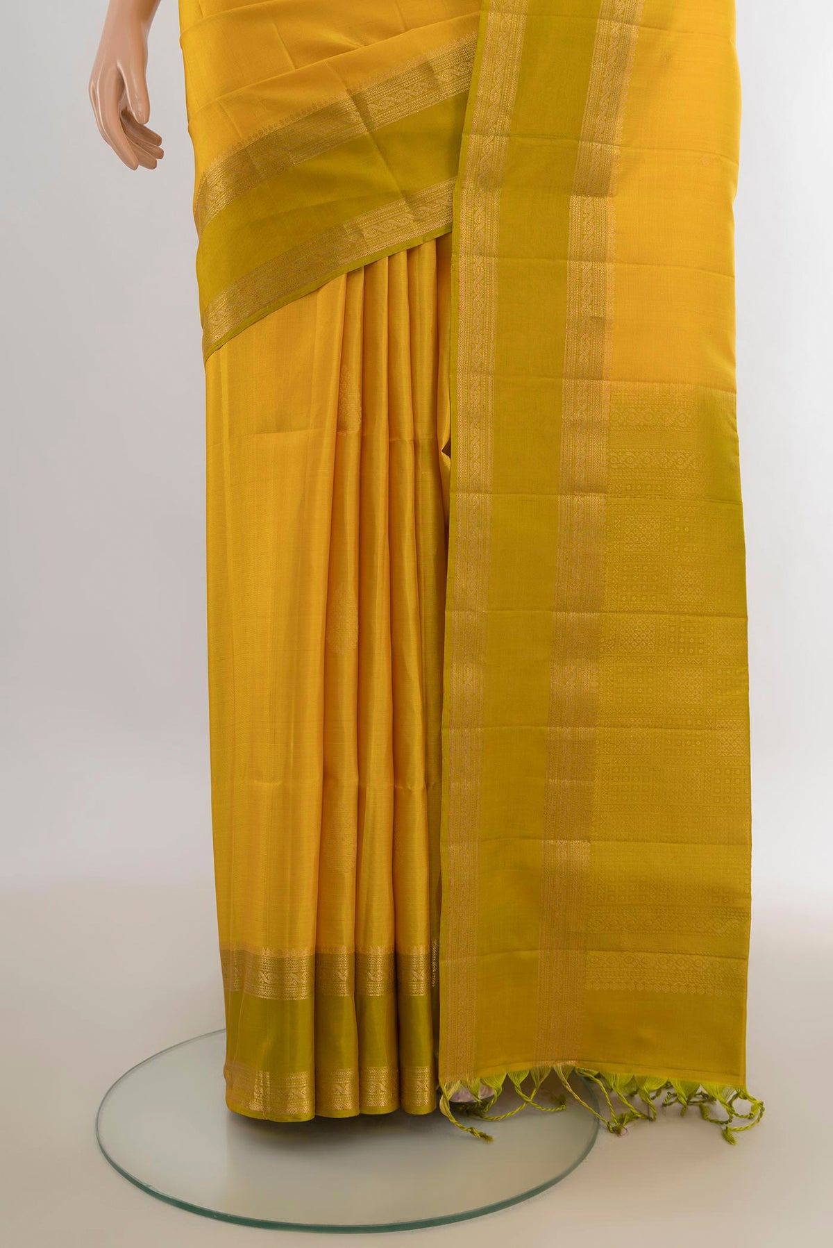 Pleats and pallu of Pure Silk Mustard Soft Saree with Zari Butta on the body and Zari Border. 
